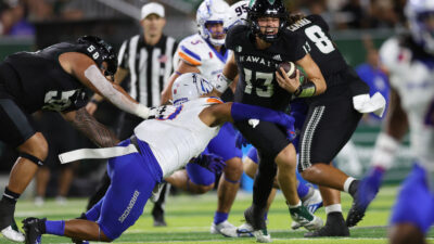 Penn State Nittany Lions quarterback Drew Allar (15) is sacked by Boise State Broncos linebacker Andrew Simpson (10) during their Vrbo Fiesta Bowl matchup at State Farm Stadium on Dec. 31