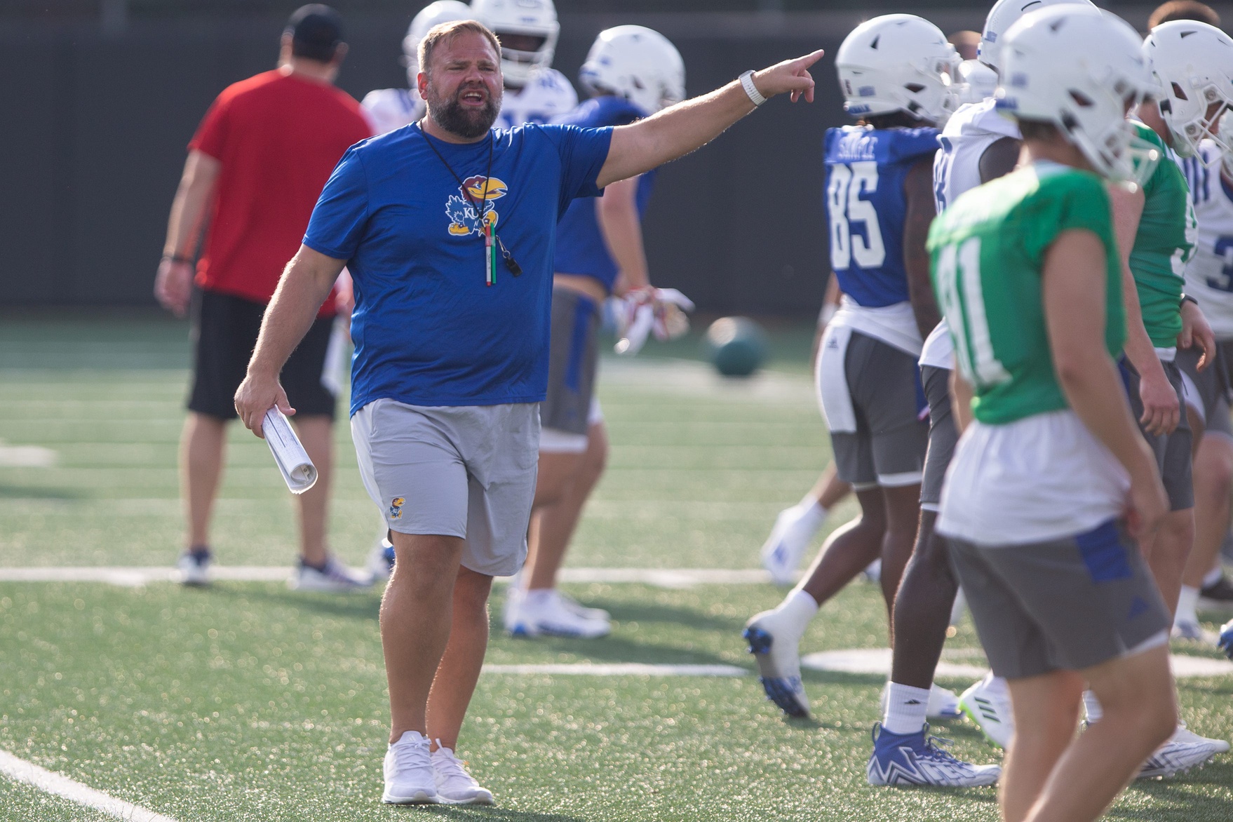 Kansas offensive coordinator Andy Kotelnicki yells out instructions during Tuesday's outdoor practice.