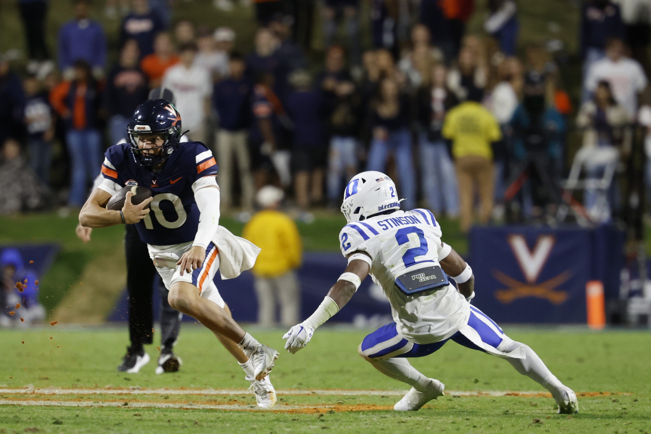 Nov 18, 2023; Charlottesville, Virginia, USA; Virginia Cavaliers quarterback Anthony Colandrea (10) carries the ball as Duke Blue Devils safety Jaylen Stinson (2) chases during the fourth quarter at Scott Stadium.