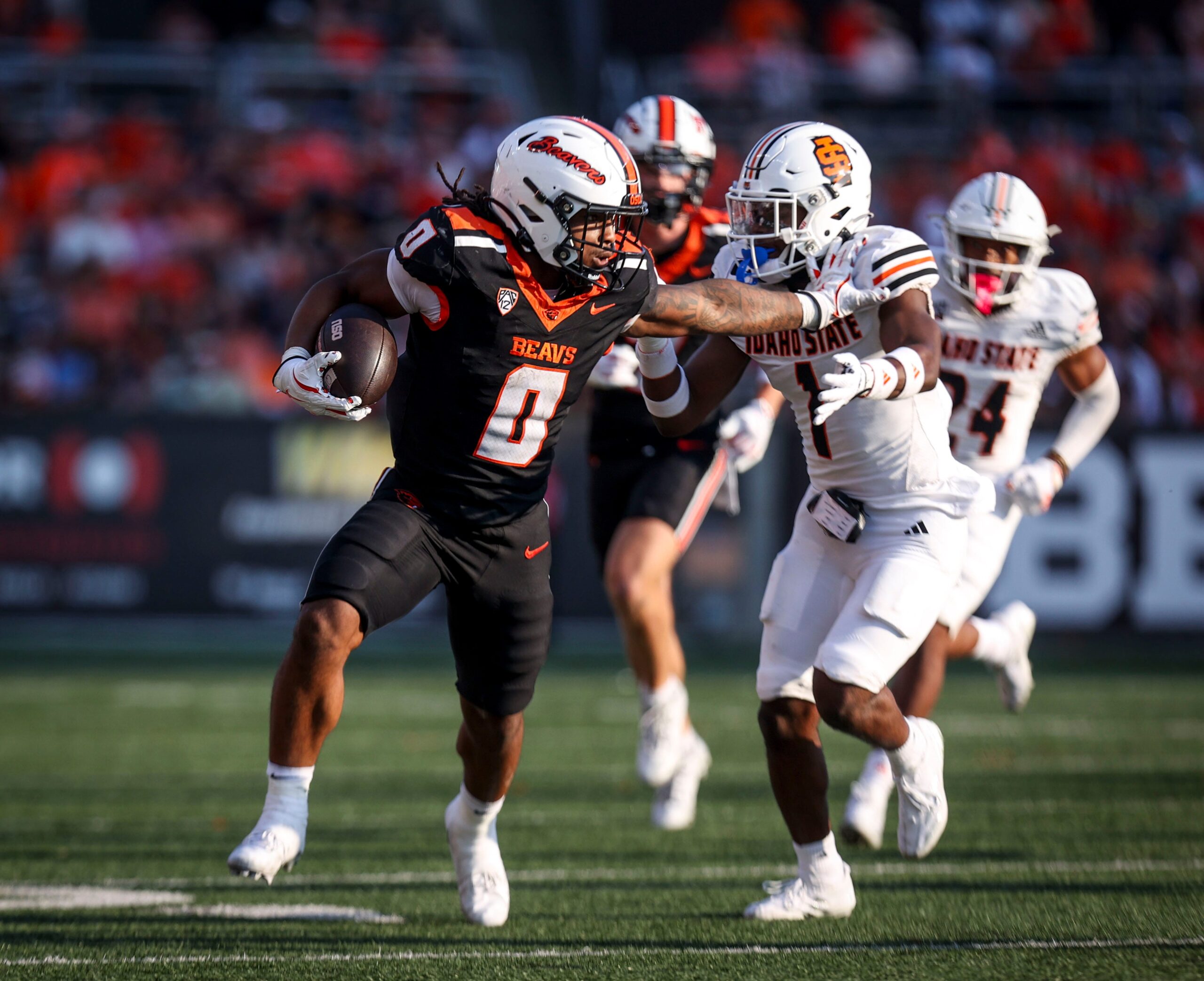 Oregon State Beavers running back Anthony Hankerson (0) fight off Idaho State defense during the second half on Saturday, Aug. 31, 2024 at Reser Stadium in Corvallis, Ore.