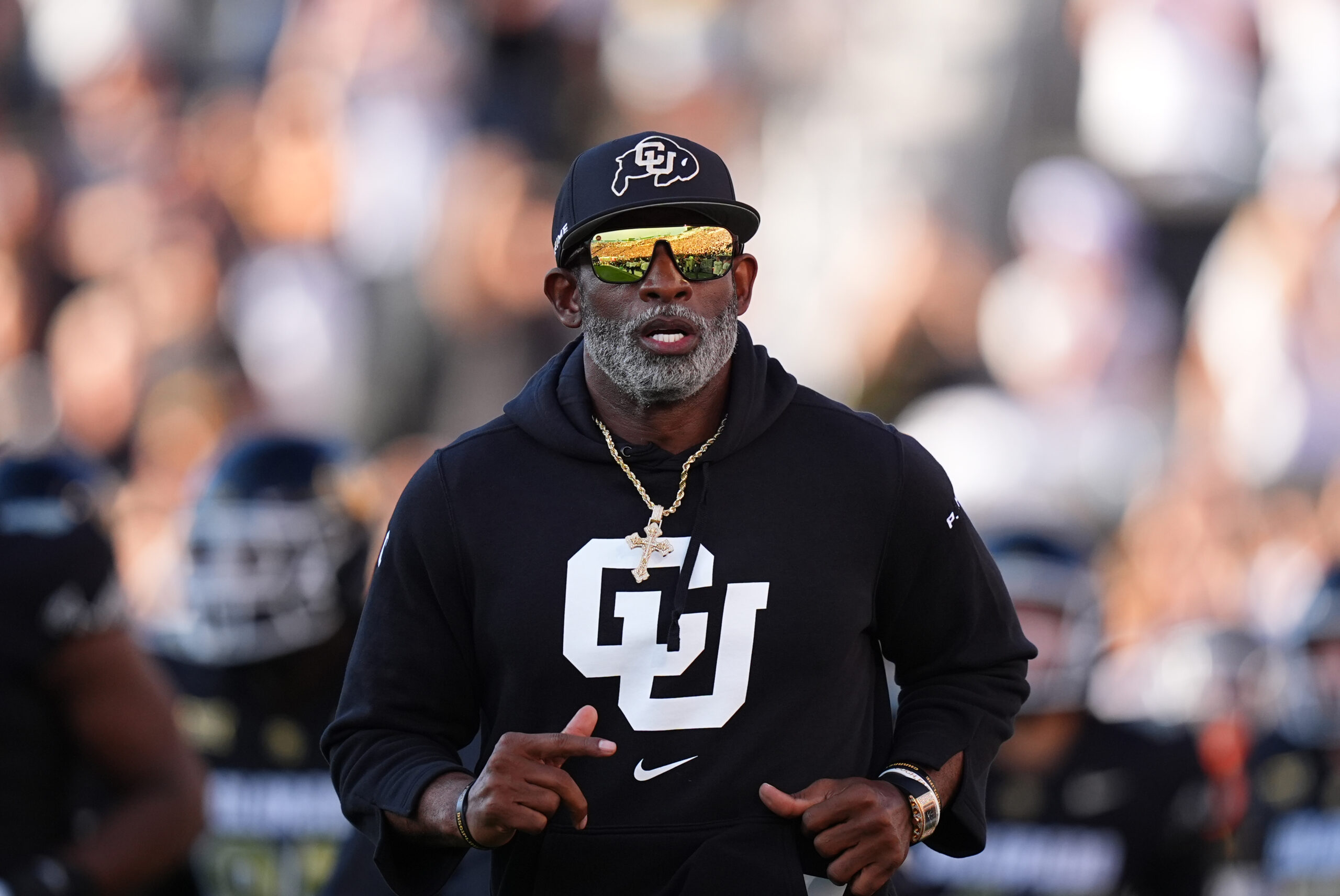 Aug 29, 2024; Boulder, Colorado, USA; Colorado Buffaloes head coach Deion Sanders runs onto the field before the game against the North Dakota State Bison at Folsom Field.