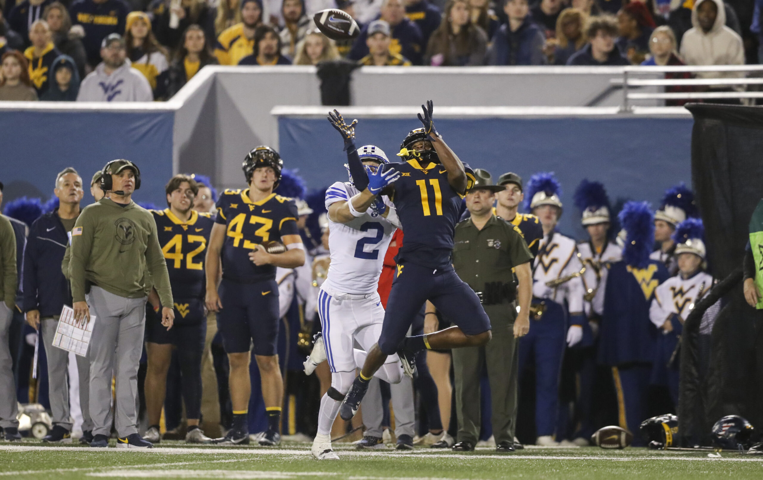 Nov 4, 2023; Morgantown, West Virginia, USA; West Virginia Mountaineers cornerback Beanie Bishop Jr. (11) defends against a pass intended for Brigham Young Cougars wide receiver Chase Roberts (2) during the second quarter at Mountaineer Field at Milan Puskar Stadium.