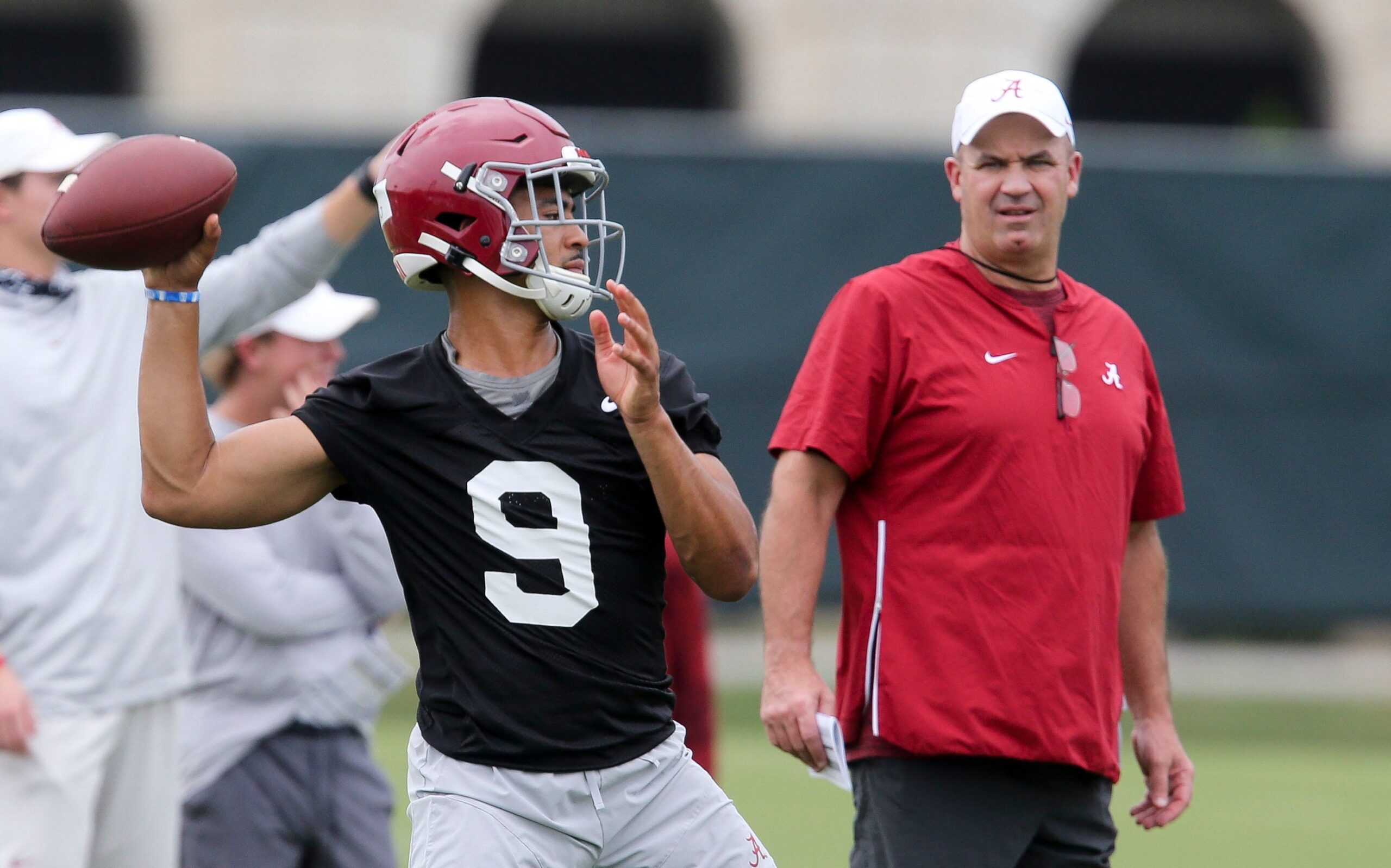 Alabama offensive coordinator Bill O'Brien watches quarterback Bryce Young throw during practice before the 2021 football season. 