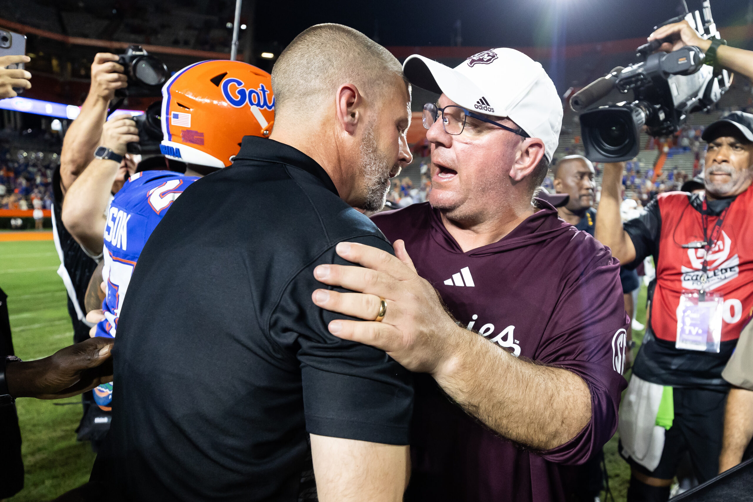 Sep 14, 2024; Gainesville, Florida, USA; Florida Gators head coach Billy Napier and Texas A&M Aggies head coach Mike Elko embrace after the game at Ben Hill Griffin Stadium.