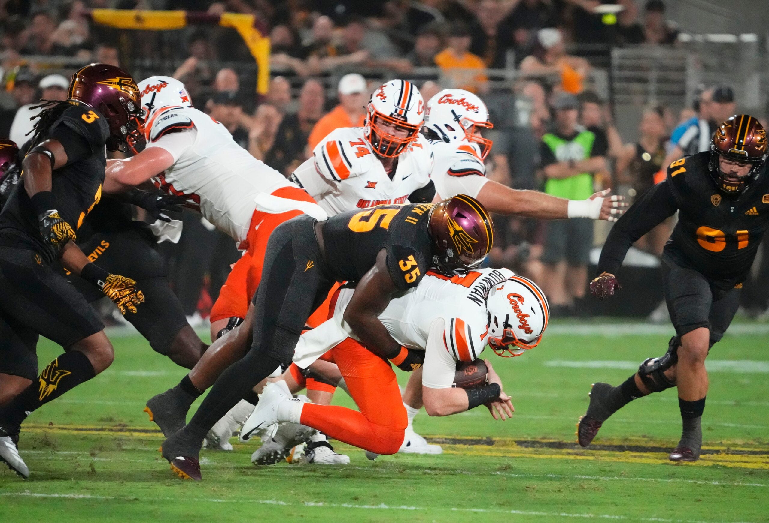 Arizona State Sun Devils defensive lineman B.J. Green II (35) sacks Oklahoma State Cowboys quarterback Alan Bowman (7) in the first half at Mountain America Stadium in Tempe on Sept. 9, 2023.