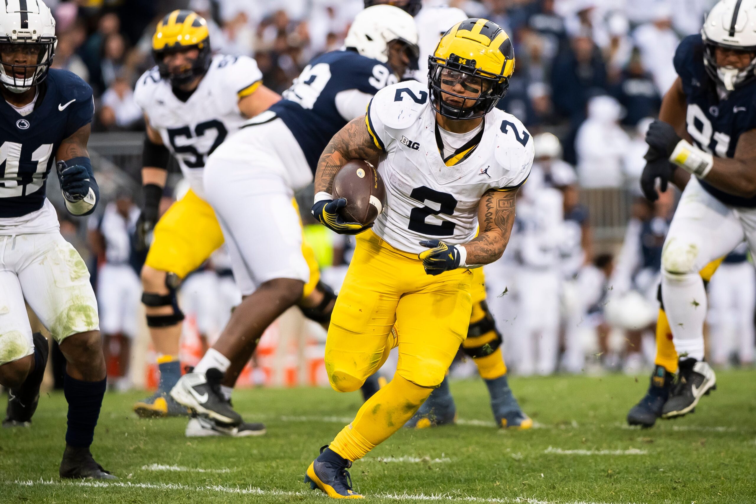 Michigan running back Blake Corum (2) takes off on a 30-yard touchdown run in the second half of an NCAA football game against Penn State Saturday, Nov. 11, 2023, in State College, Pa.