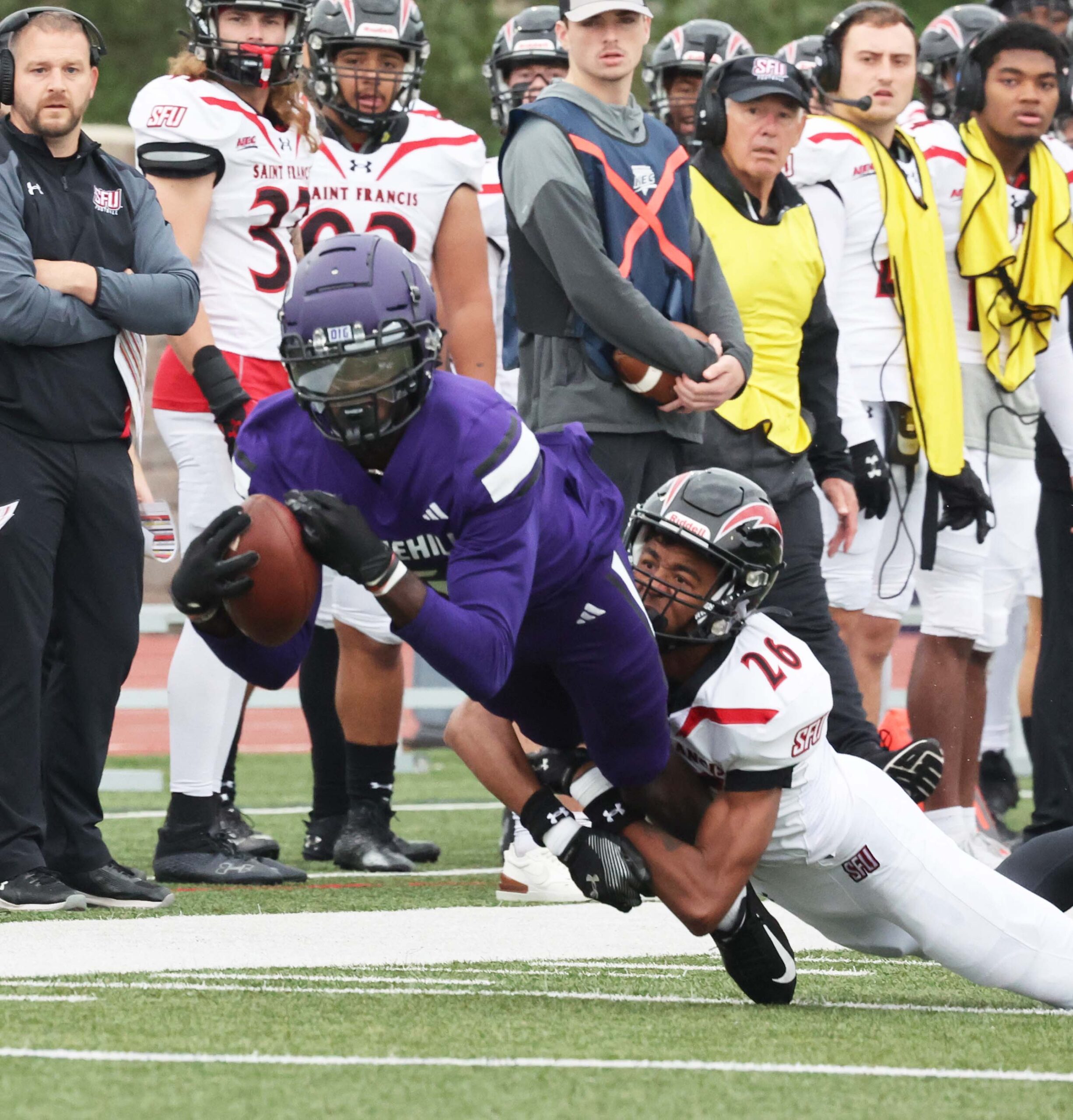 Stonehill College receiver Chris Domercant is tackled by St. Francis University defender Blye Hill during a game on Saturday, Sept. 30, 2023.