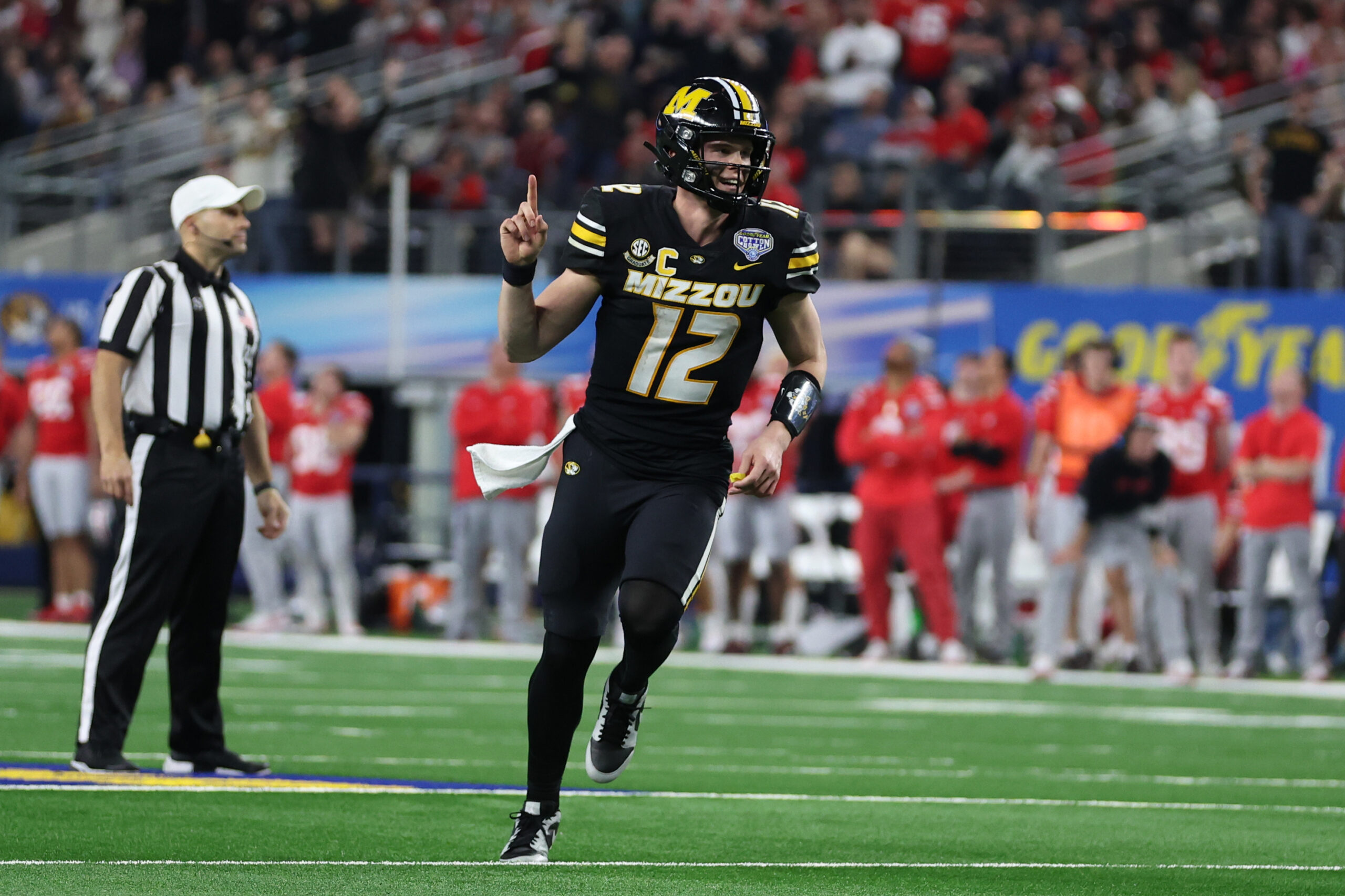 Dec 29, 2023; Arlington, TX, USA; Missouri Tigers quarterback Brady Cook (12) celebrates throwing a touchdown pass against the Ohio State Buckeyes in the fourth quarter at AT&T Stadium.