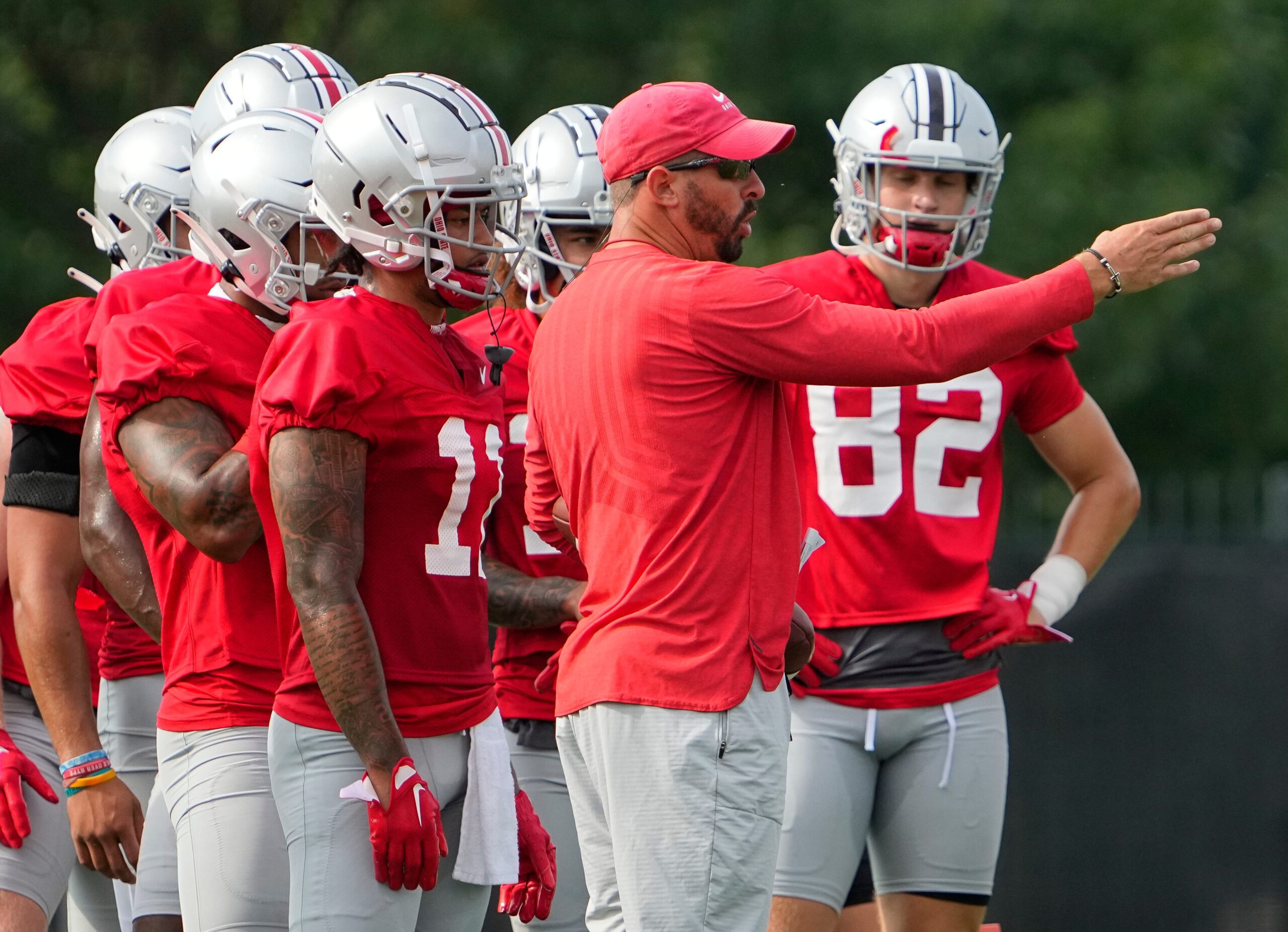 Aug 4, 2022; Columbus, OH, USA; Ohio State Buckeyes passing game coordinator Brian Hartline talks to his wide receivers during the first fall football practice at the Woody Hayes Athletic Center.