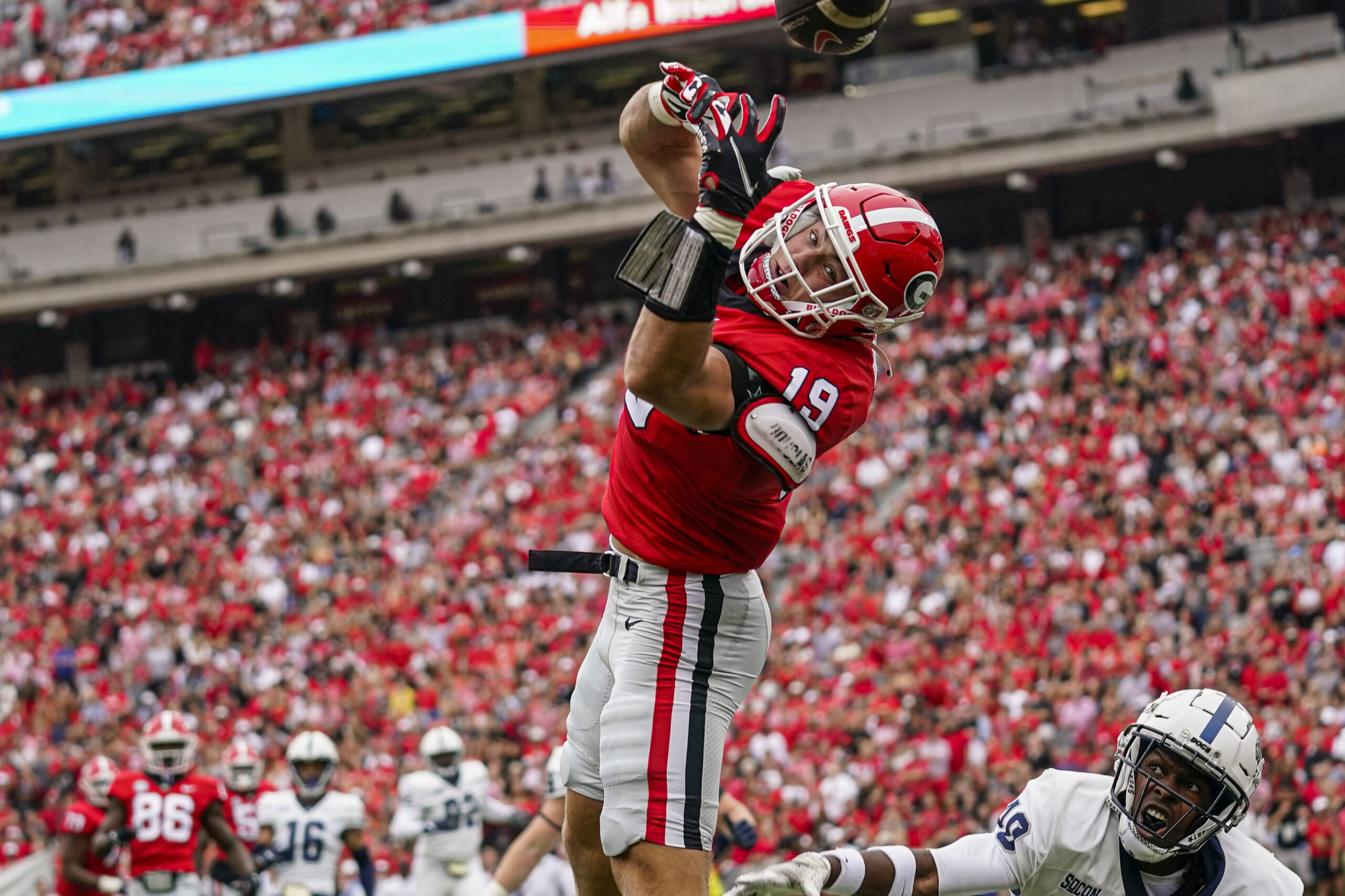 Sep 10, 2022; Athens, Georgia, USA; Georgia Bulldogs tight end Brock Bowers (19) can t hold a pass over Samford Bulldogs safety Wade White (40) in the end zone during the first half at Sanford Stadium.