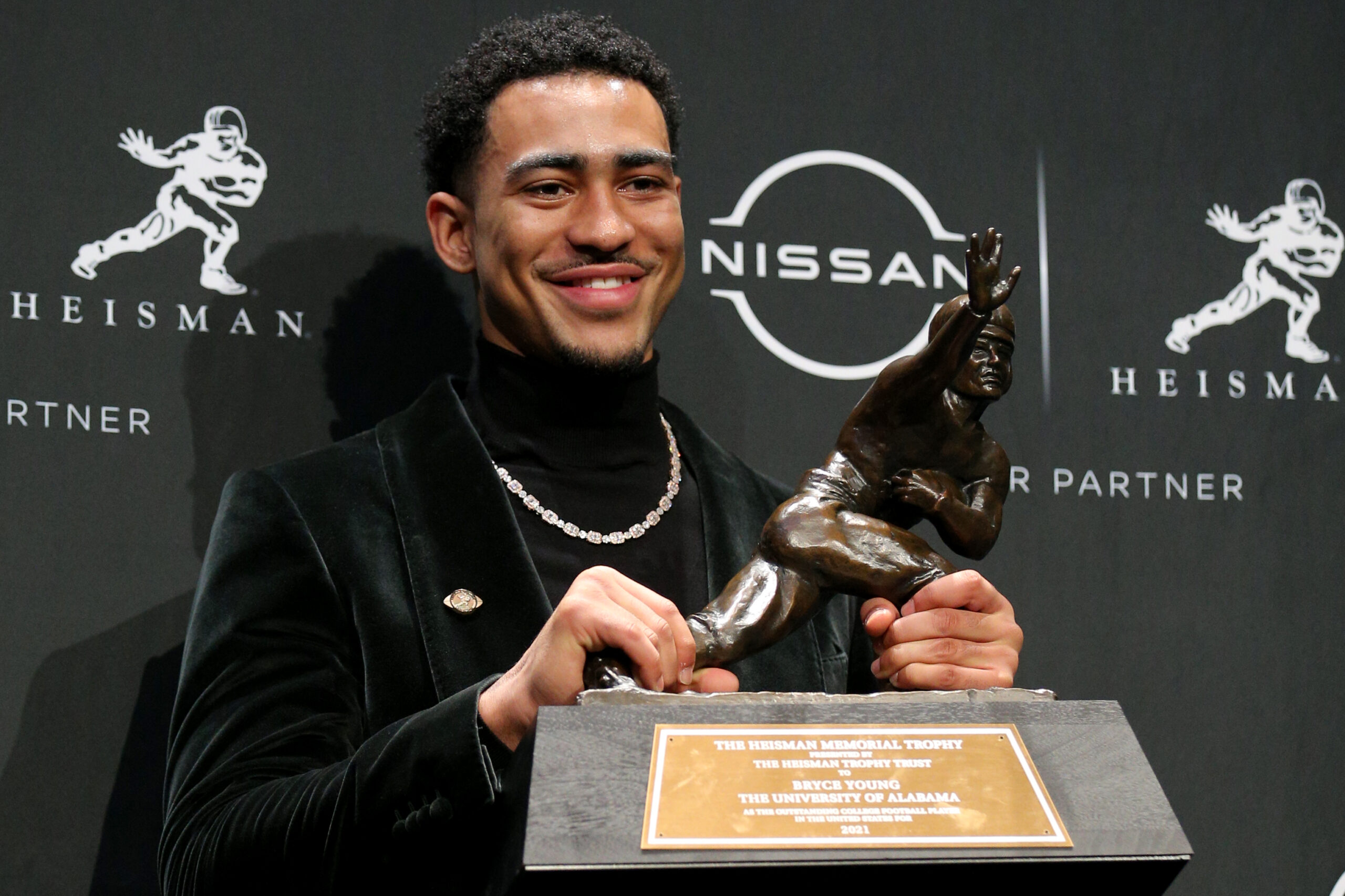 Dec 11, 2021; New York, NY, USA; 2021 Heisman winner Alabama quarterback Bryce Young poses for pictures with the trophy during a press conference at the New York Marriott Marquis in New York City. Mandatory Credit: