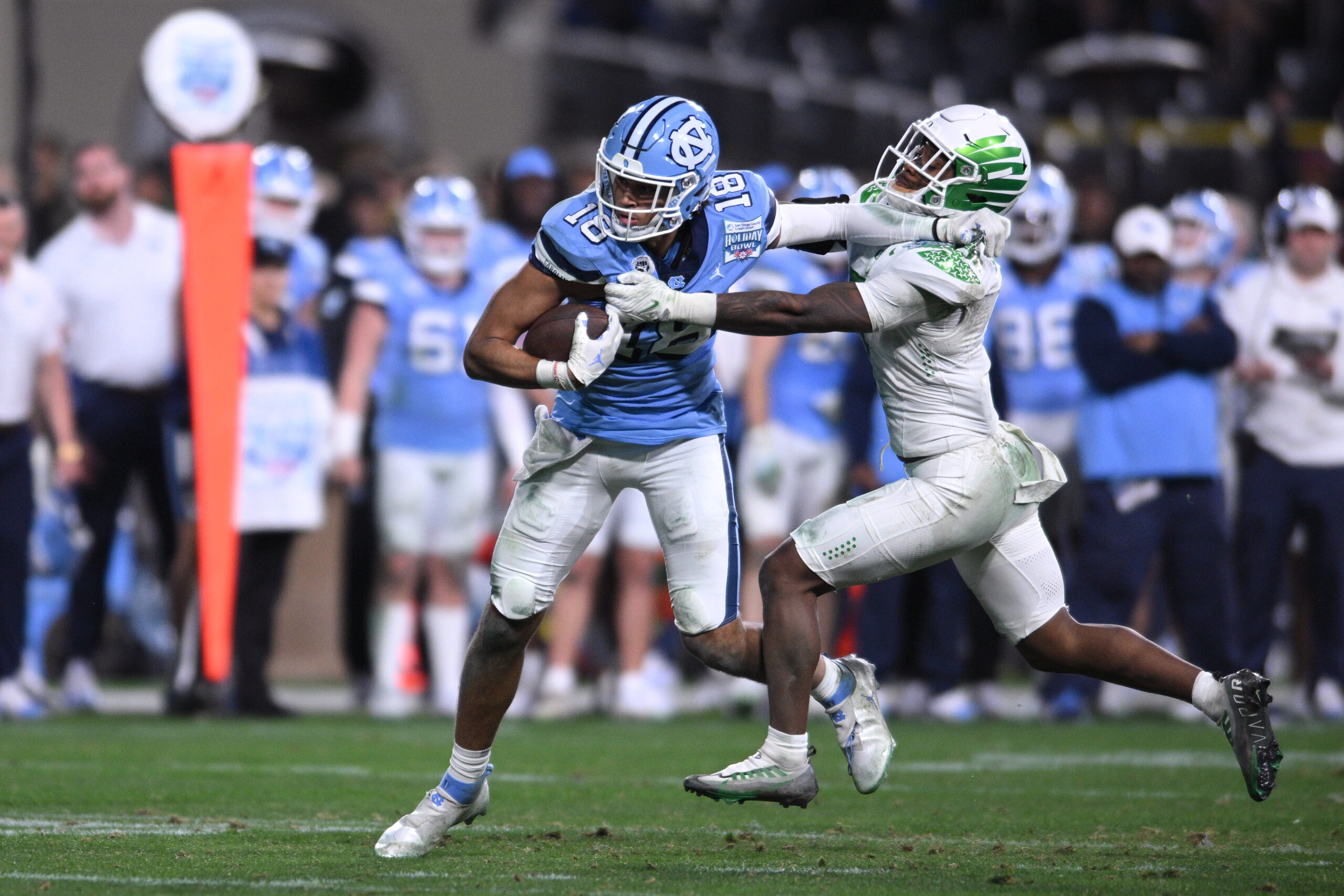 Dec 28, 2022; San Diego, CA, USA; North Carolina Tar Heels tight end Bryson Nesbit (18) runs with the ball while defended by Oregon Ducks defensive back Steve Stephens IV (7) during the second half of the 2022 Holiday Bowl at Petco Park.