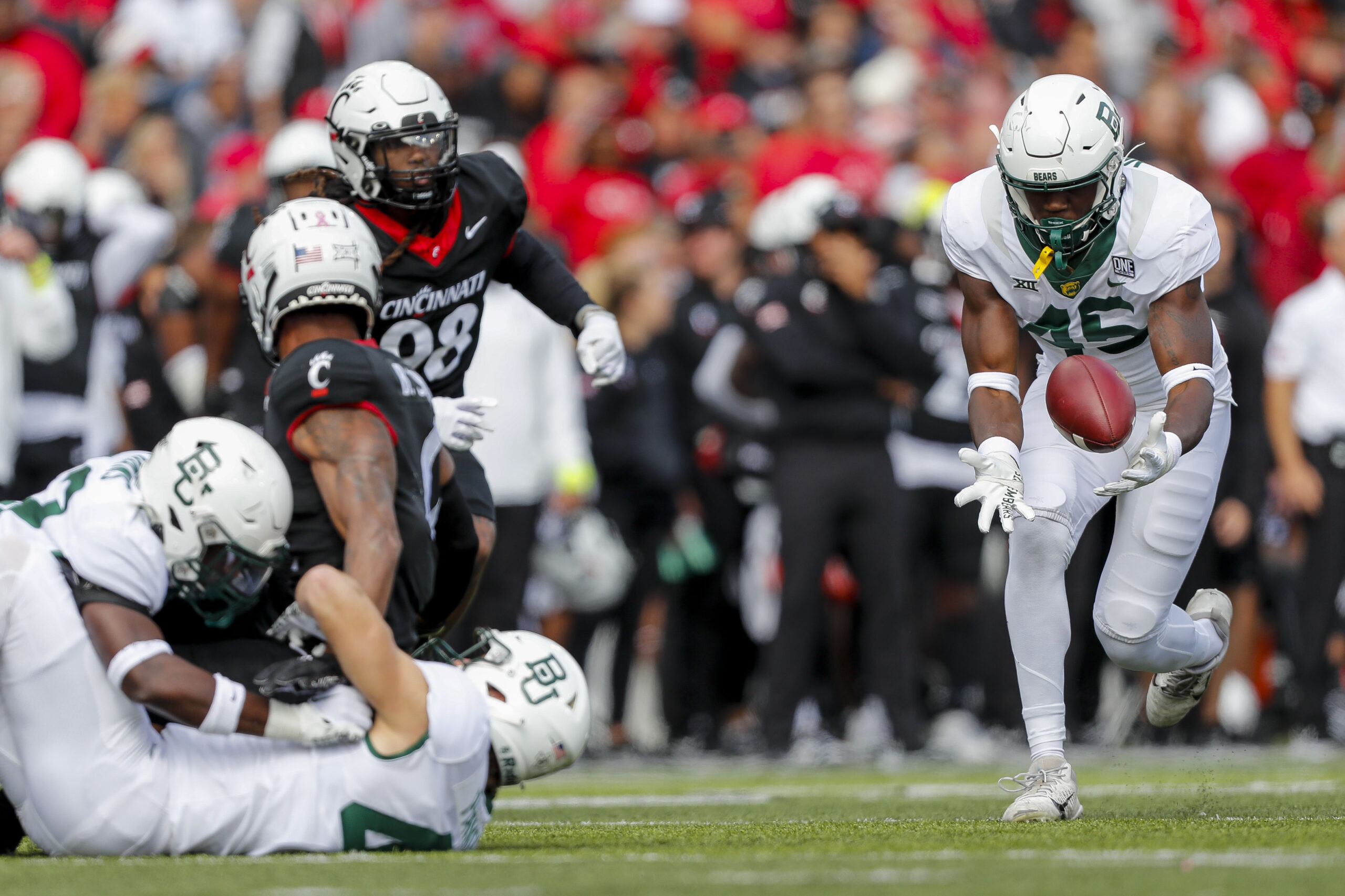 Oct 21, 2023; Cincinnati, Ohio, USA; Baylor Bears linebacker Byron Vaughns (45) recovers a fumble and returns it for a touchdown against the Cincinnati Bearcats in the first half at Nippert Stadium.