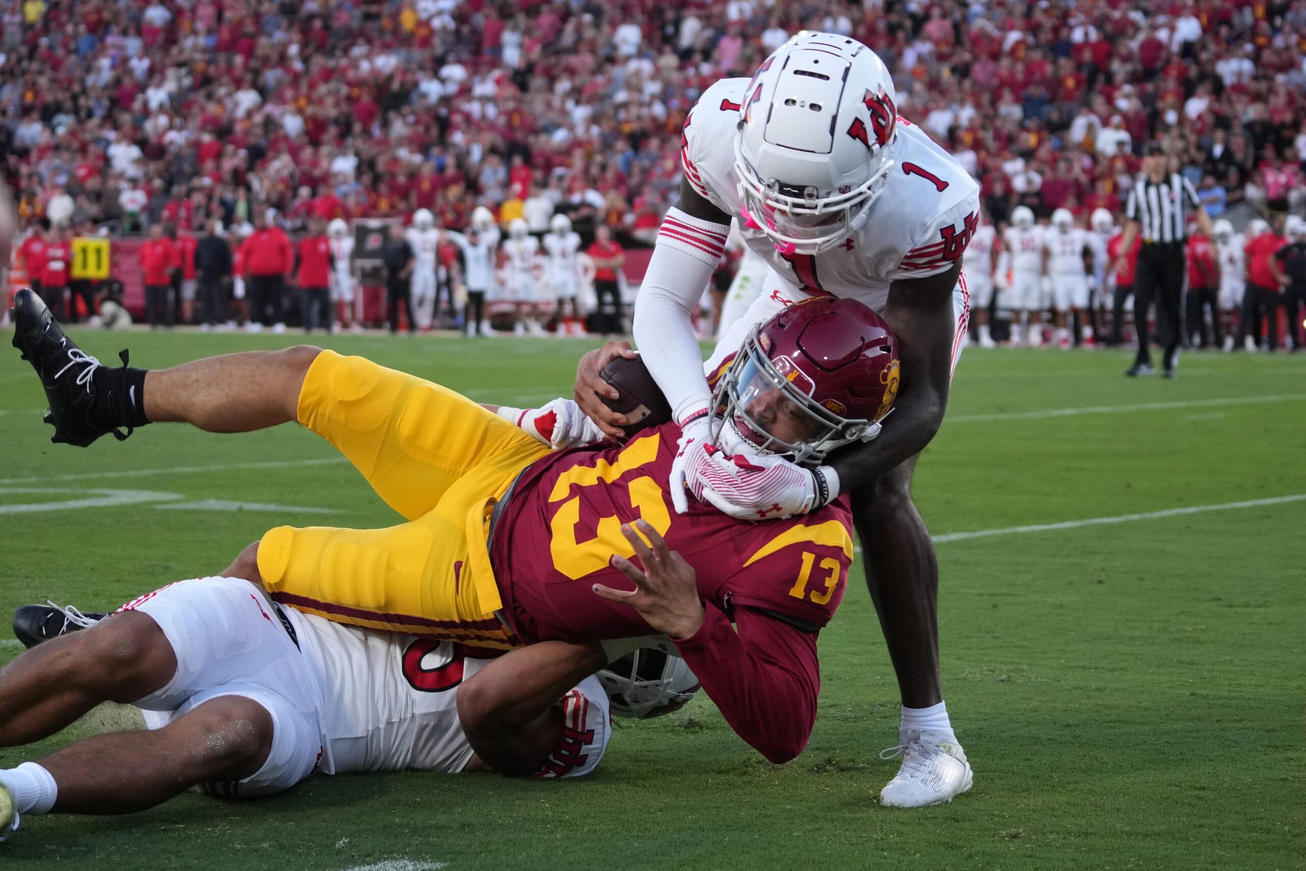 Oct 21, 2023; Los Angeles, California, USA; Southern California Trojans quarterback Caleb Williams (13) carries the ball against Utah Utes cornerback Miles Battle (1) and defensive end Jonah Elliss (83) in the first half at United Airlines Field at Los Angeles Memorial Coliseum.