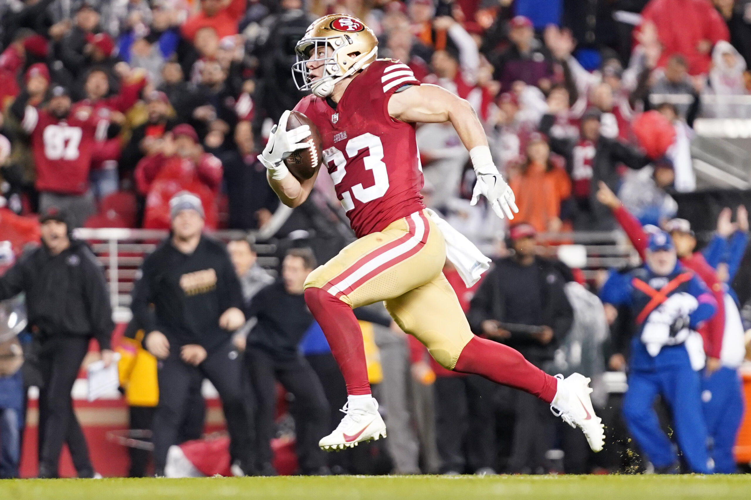 January 20, 2024; Santa Clara, CA, USA; San Francisco 49ers running back Christian McCaffrey (23) runs to score a touchdown against the Green Bay Packers during the third quarter in a 2024 NFC divisional round game at Levi's Stadium.