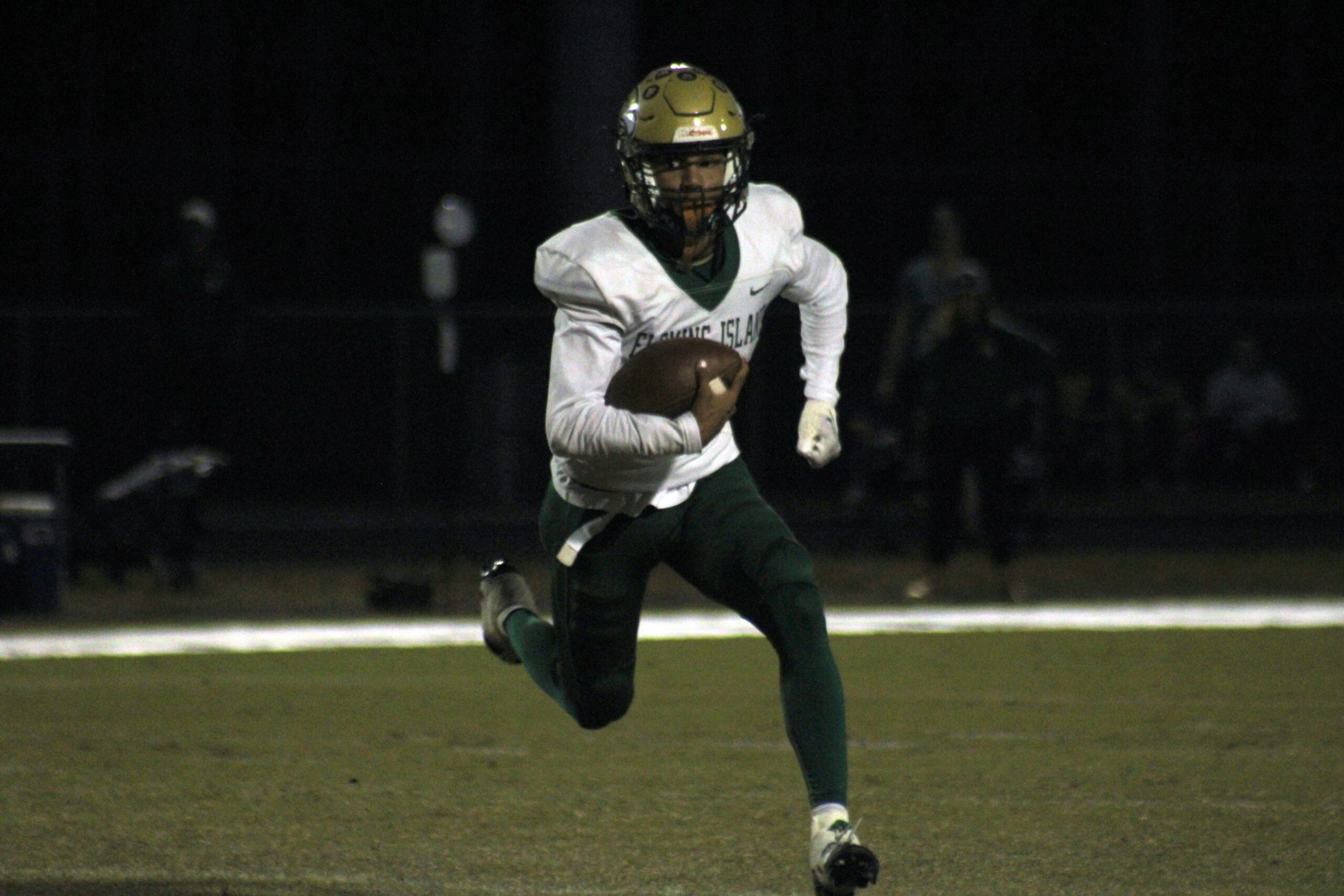 Fleming Island quarterback Cibastian Broughton (1) scrambles for yardage against Creekside during a high school football game on October 20, 2023. 
