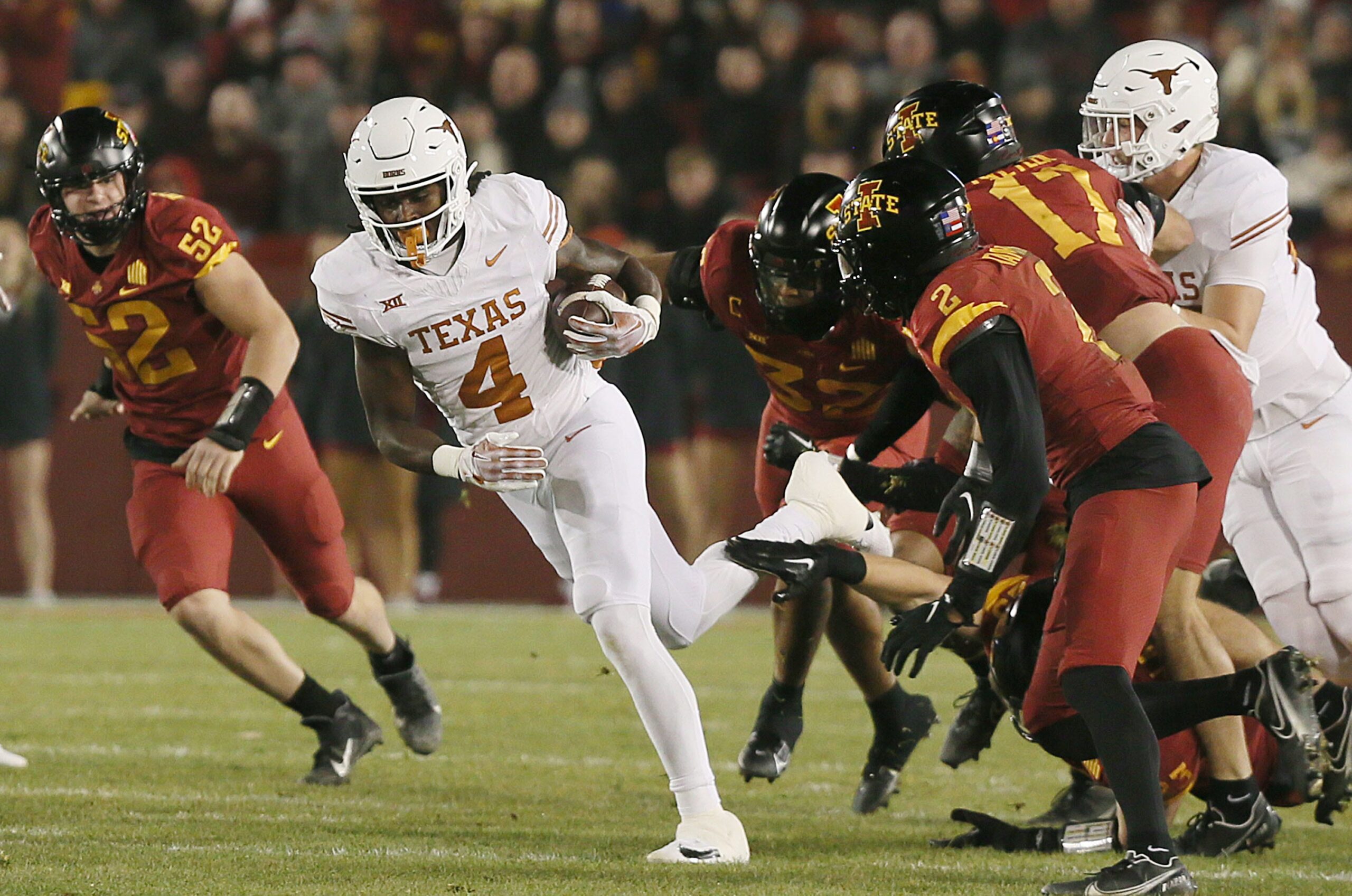 Texas Longhorns running back CJ Baxter (4) runs with the ball for a first down against Iowa State during the first quarter in the Big-12 football showdown at Jack Trice Stadium on Saturday, Nov. 18, 2023, in Ames, Iowa