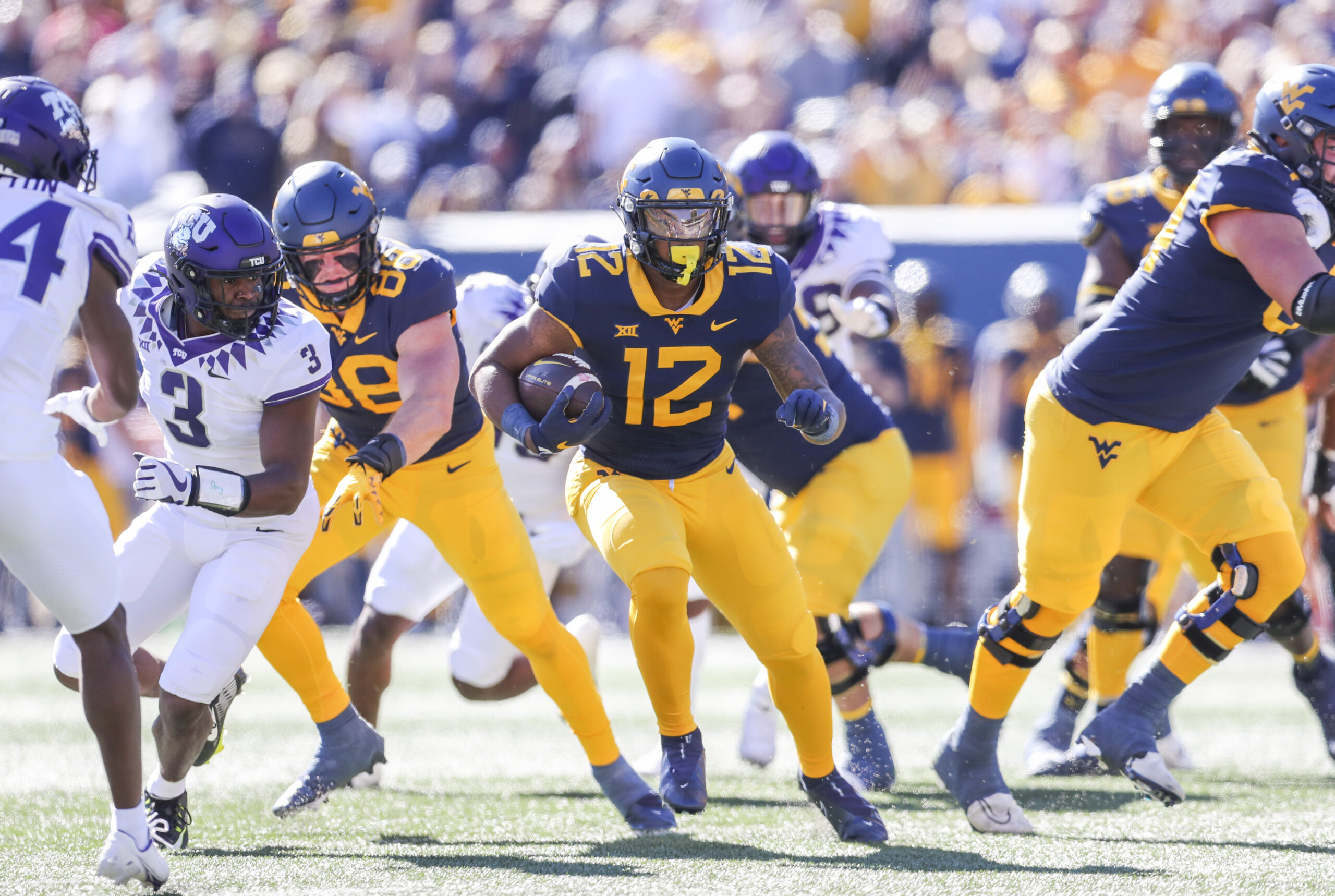 Oct 29, 2022; Morgantown, West Virginia, USA; West Virginia Mountaineers running back CJ Donaldson (12) runs the ball during the first quarter against the TCU Horned Frogs at Mountaineer Field at Milan Puskar Stadium.