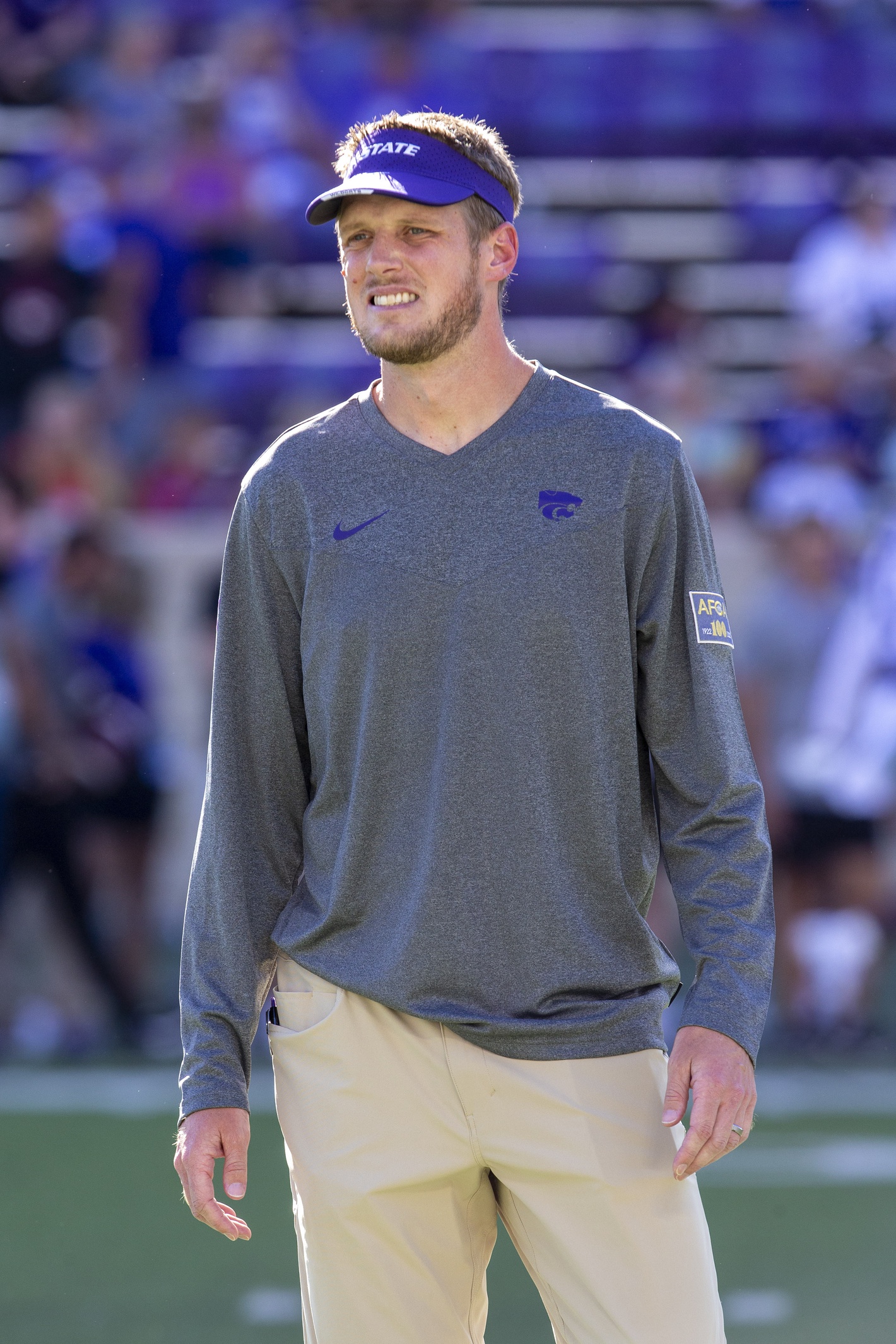 Sep 3, 2022; Manhattan, Kansas, USA; Kansas State Wildcats offensive coordinator Collin Klein watches the team warm up before the start of a game against the South Dakota Coyotes at Bill Snyder Family Football Stadium.