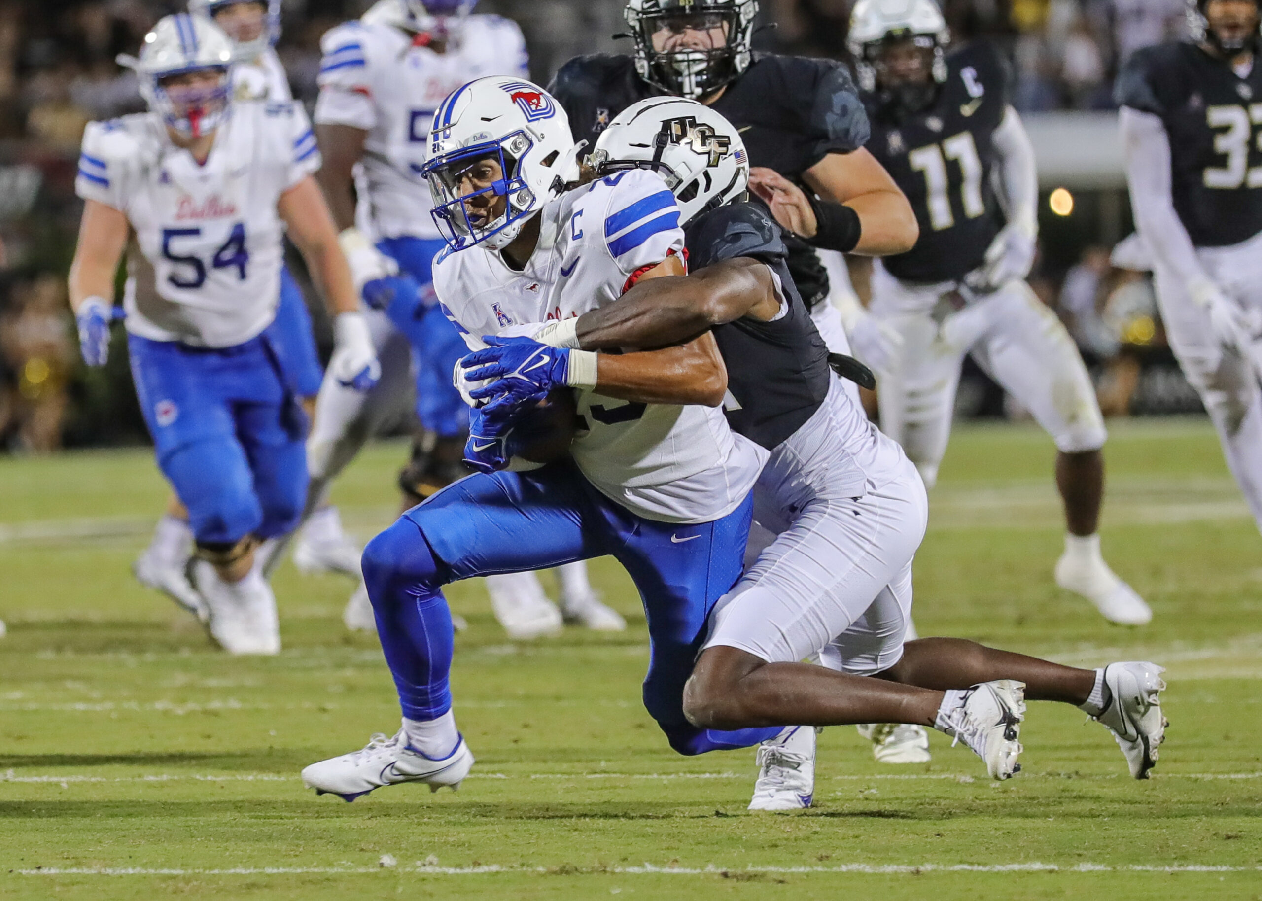 Oct 5, 2022; Orlando, Florida, USA; Southern Methodist Mustangs wide receiver Austin Upshaw (23) is tackled by UCF Knights cornerback Corey Thornton (14) during the second quarter at FBC Mortgage Stadium.