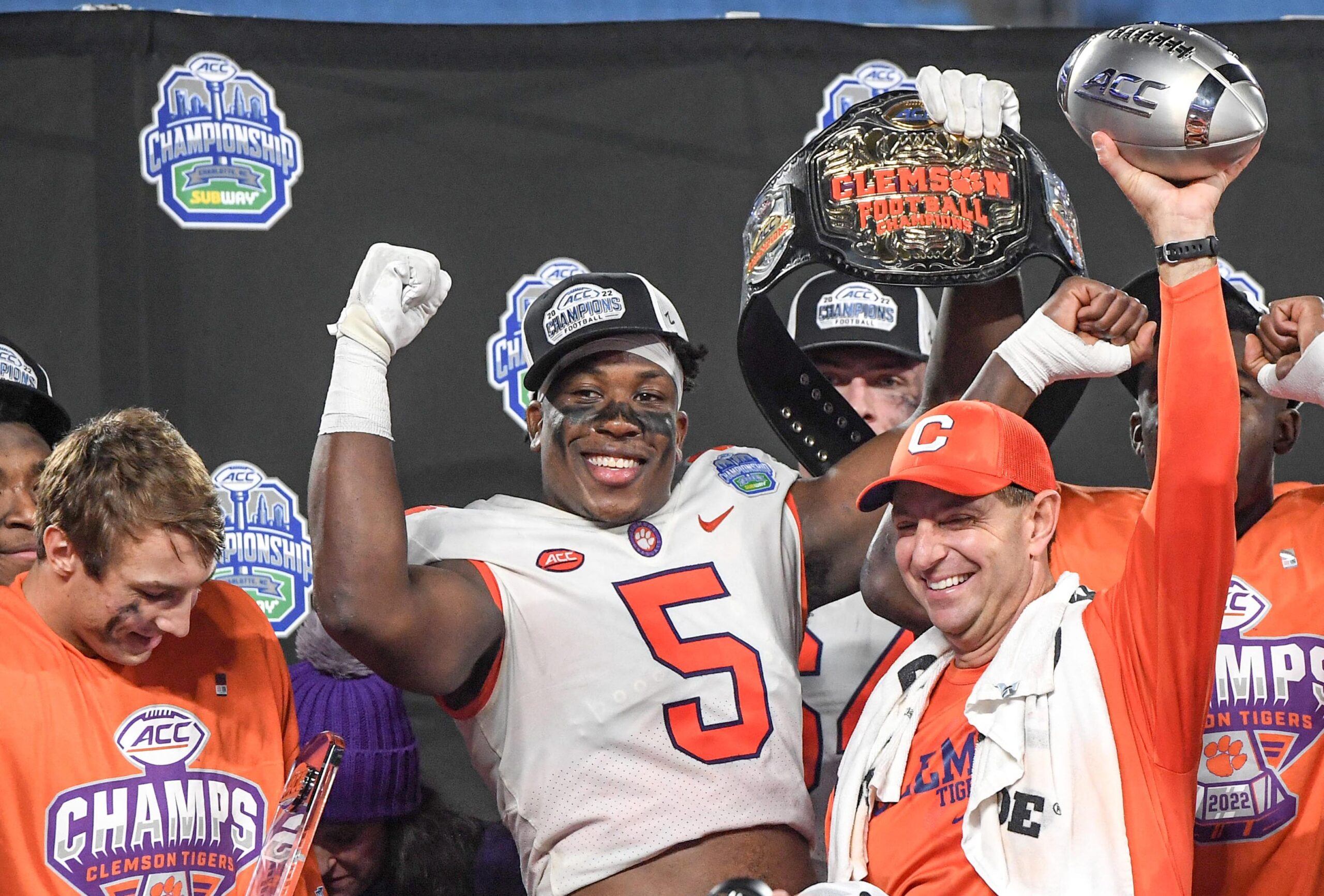 Clemson coach Dabo Swinney raises the ACC championship trophy with Tigers defensive end K.J. Henry (5) after Clemson's win against North Carolina in the ACC Championship Game at Bank of America Stadium in Charlotte, N.C., on Dec. 3, 2002.