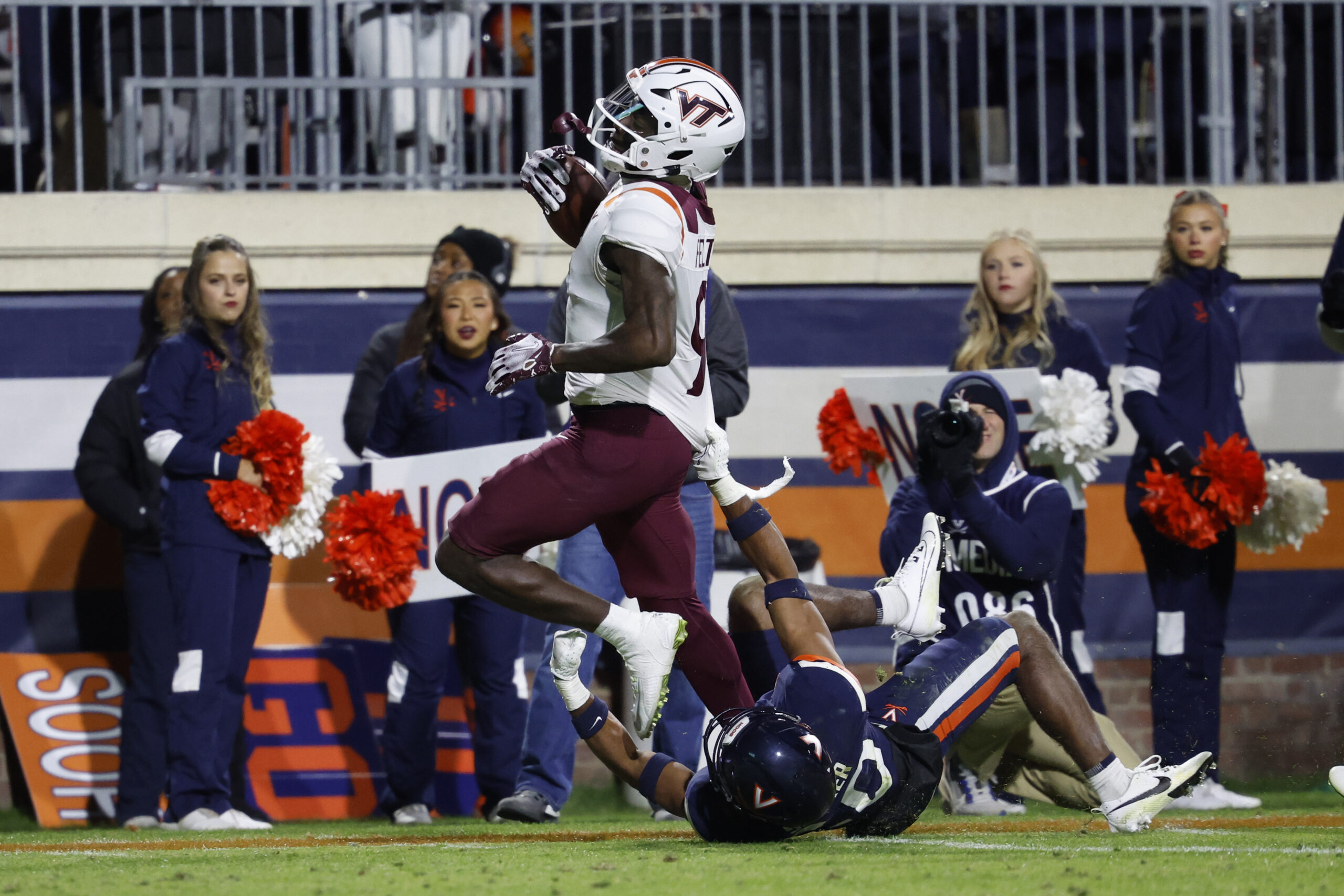 Nov 25, 2023; Charlottesville, Virginia, USA; Virginia Tech Hokies wide receiver Da'Quan Felton (9) runs with the ball en route to a touchdown as Virginia Cavaliers safety Jonas Sanker (20) attempts the tackle during the third quarter at Scott Stadium.