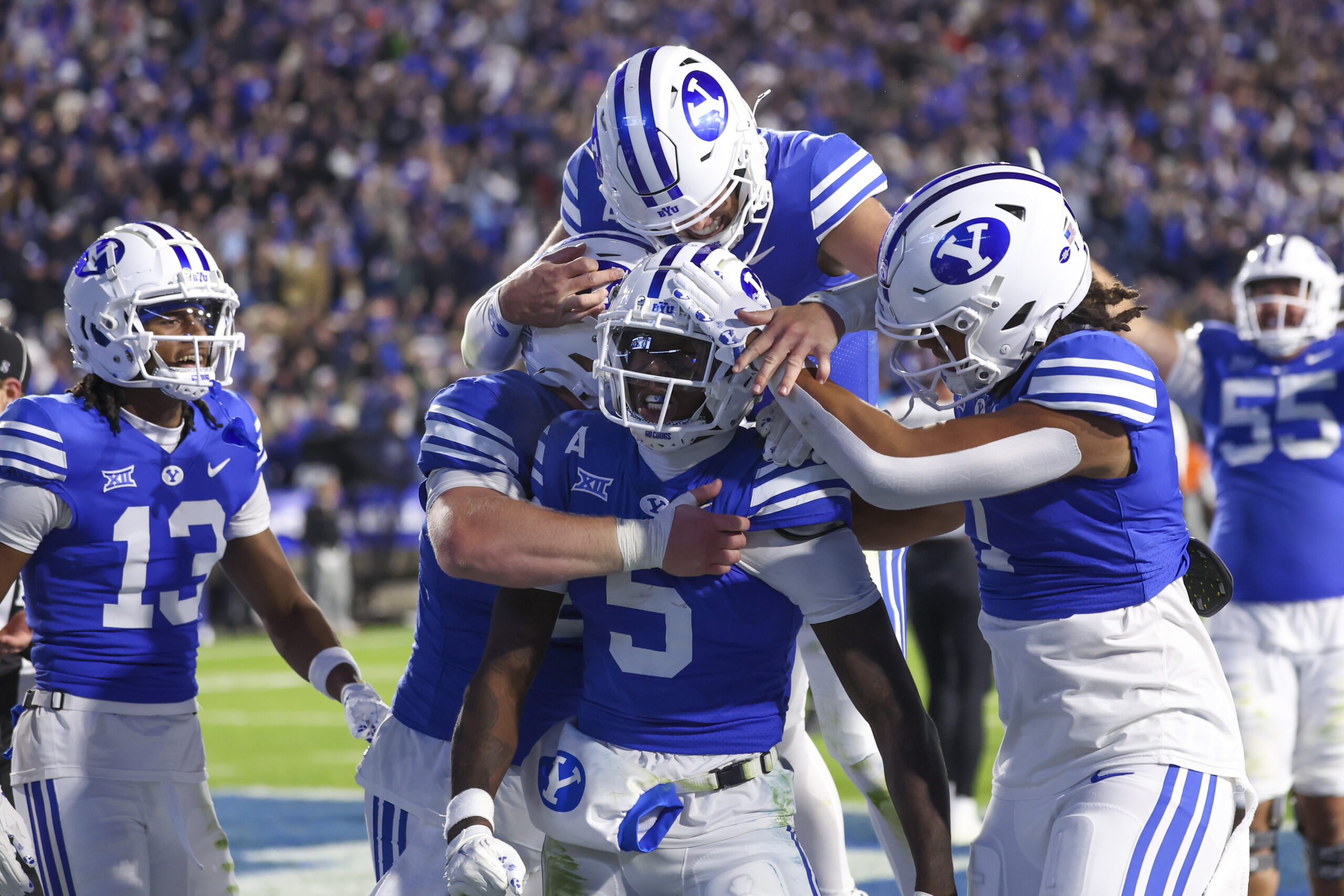 Oct 18, 2024; Provo, Utah, USA; Brigham Young Cougars wide receiver Darius Lassiter (5) celebrates a touchdown with teammates in the last minute of the game against the Oklahoma State Cowboys at LaVell Edwards Stadium.