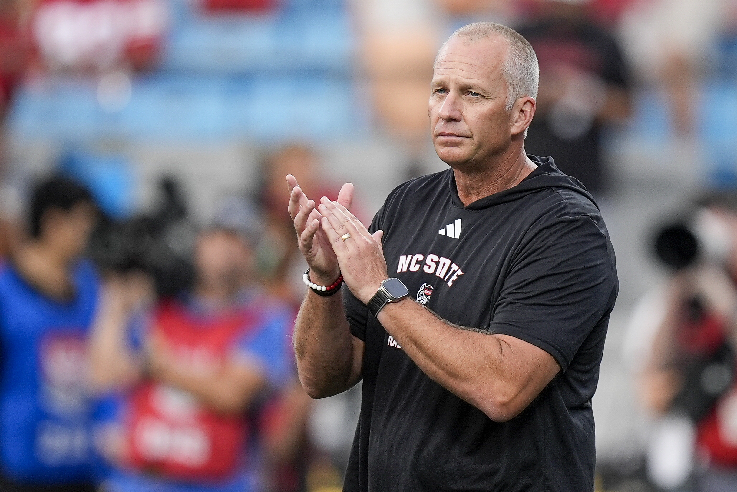 Sep 7, 2024; Charlotte, North Carolina, USA; North Carolina State Wolfpack head coach Dave Doeren during pregame activities against the Tennessee Volunteers at the Dukes Mayo Classic at Bank of America Stadium. 