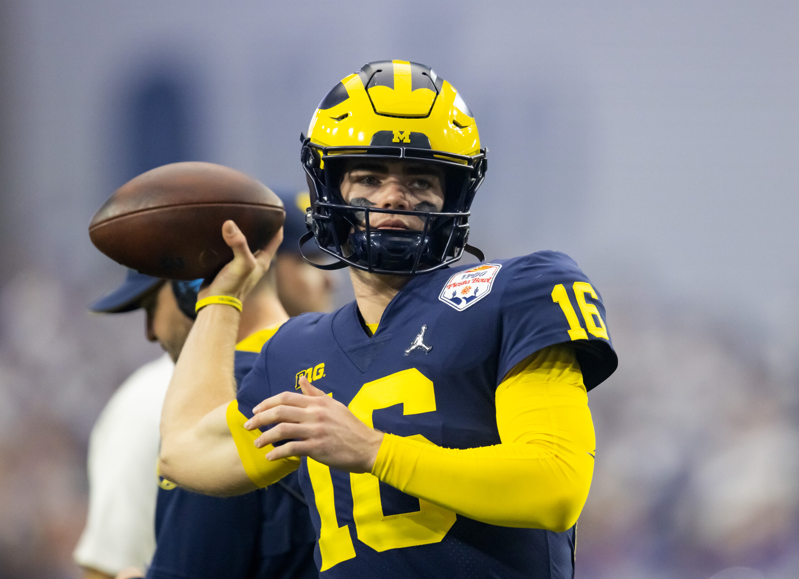 Michigan quarterback Davis Warren (16) is sacked by Texas linebacker Barryn Sorrell (88) during the second half at Michigan Stadium in Ann Arbor on Saturday, September 7, 2024.