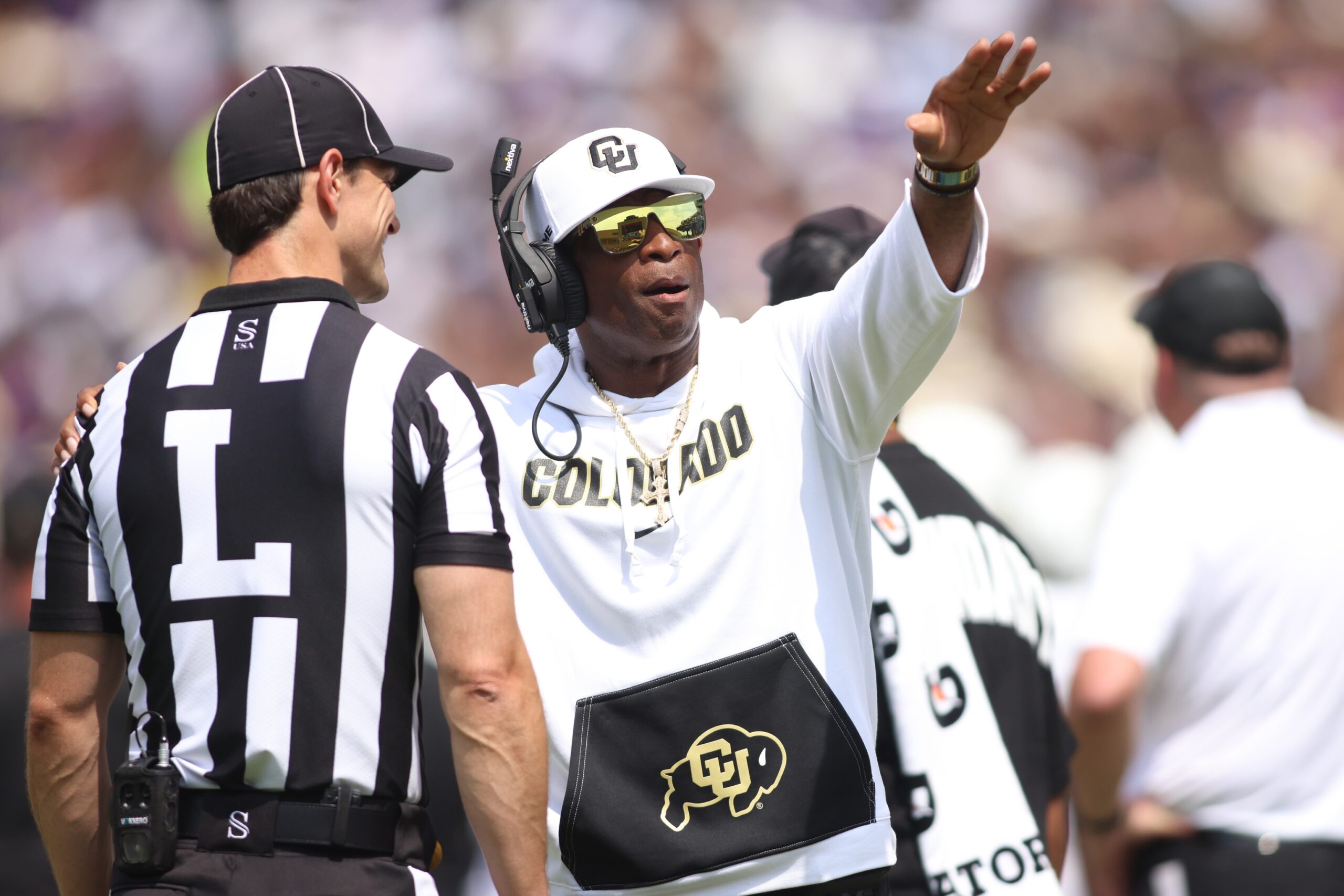 Sep 2, 2023; Fort Worth, Texas, USA; Colorado Buffaloes head coach Deion Sanders talks to line judge Bret bascule in the second quarter against the TCU Horned Frogs at Amon G. Carter Stadium.