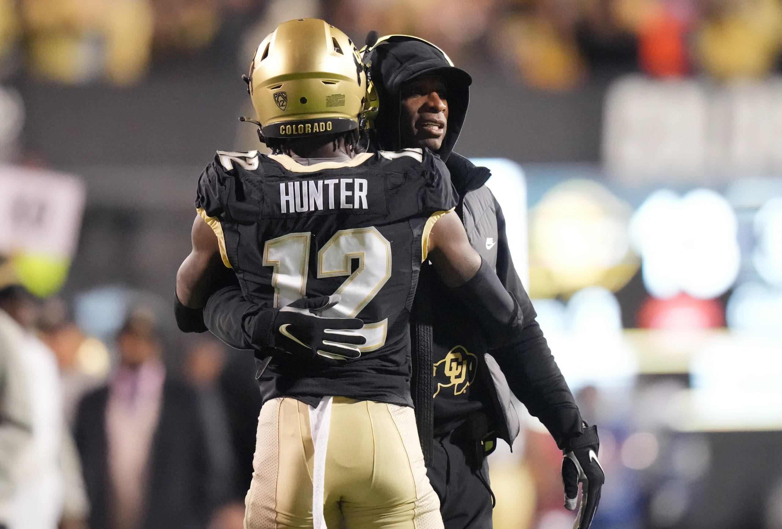 Boulder, Colorado, USA; Colorado Buffaloes wide receiver Travis Hunter (12) is congratulated for his touchdown by head coach Deion Sanders in the first quarter against the Stanford Cardinal at Folsom Field.