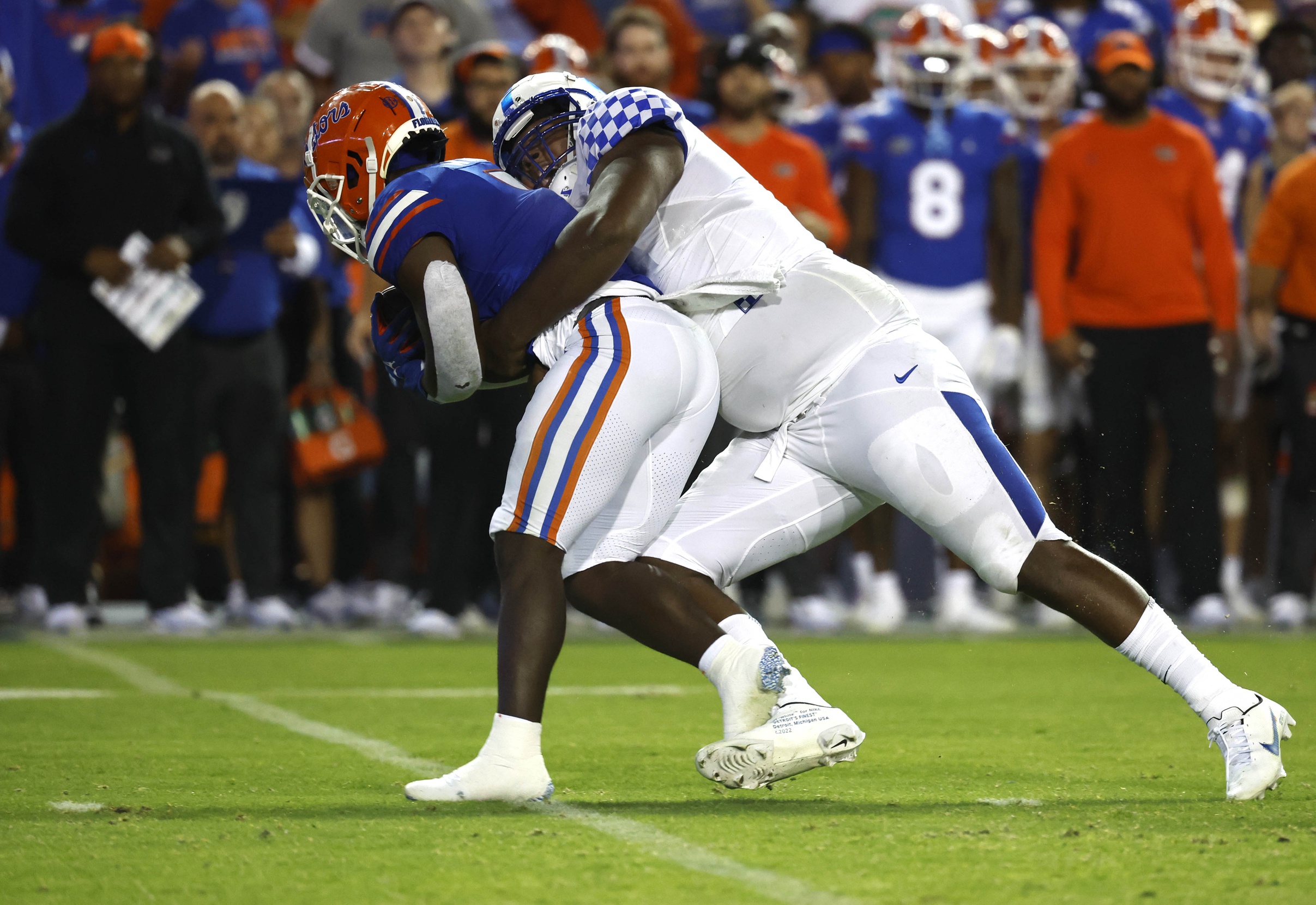 Sep 10, 2022; Gainesville, Florida, USA; Kentucky Wildcats defensive tackle Deone Walker (0) tackles Florida Gators running back Nay'Quan Wright (5) during the second half at Ben Hill Griffin Stadium.