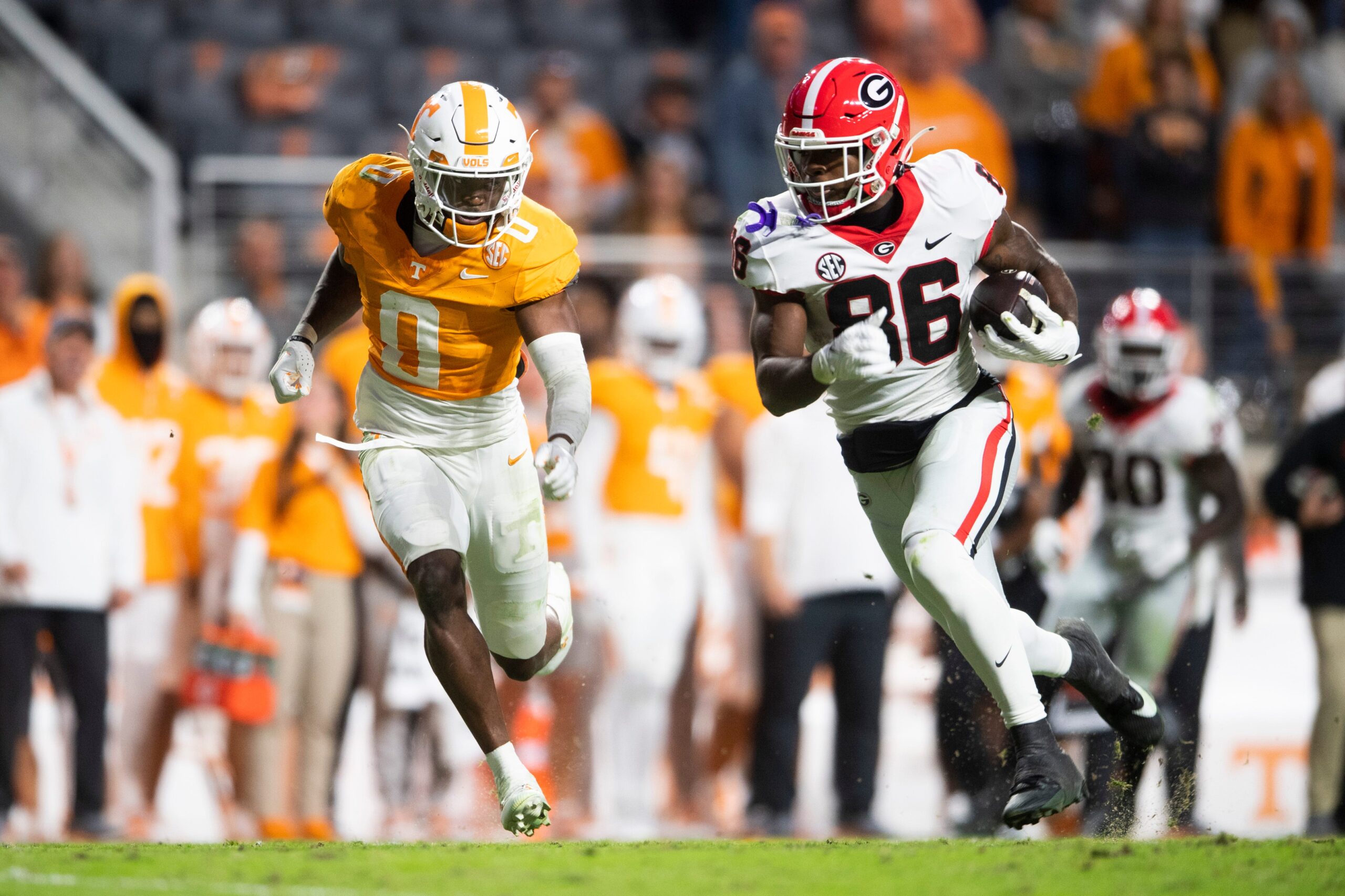 Georgia wide receiver Dillon Bell (86) runs the ball while defended by Tennessee defensive back Doneiko Slaughter (0) during a football game between Tennessee and Georgia at Neyland Stadium in Knoxville, Tenn., on Saturday, Nov. 18, 2023.