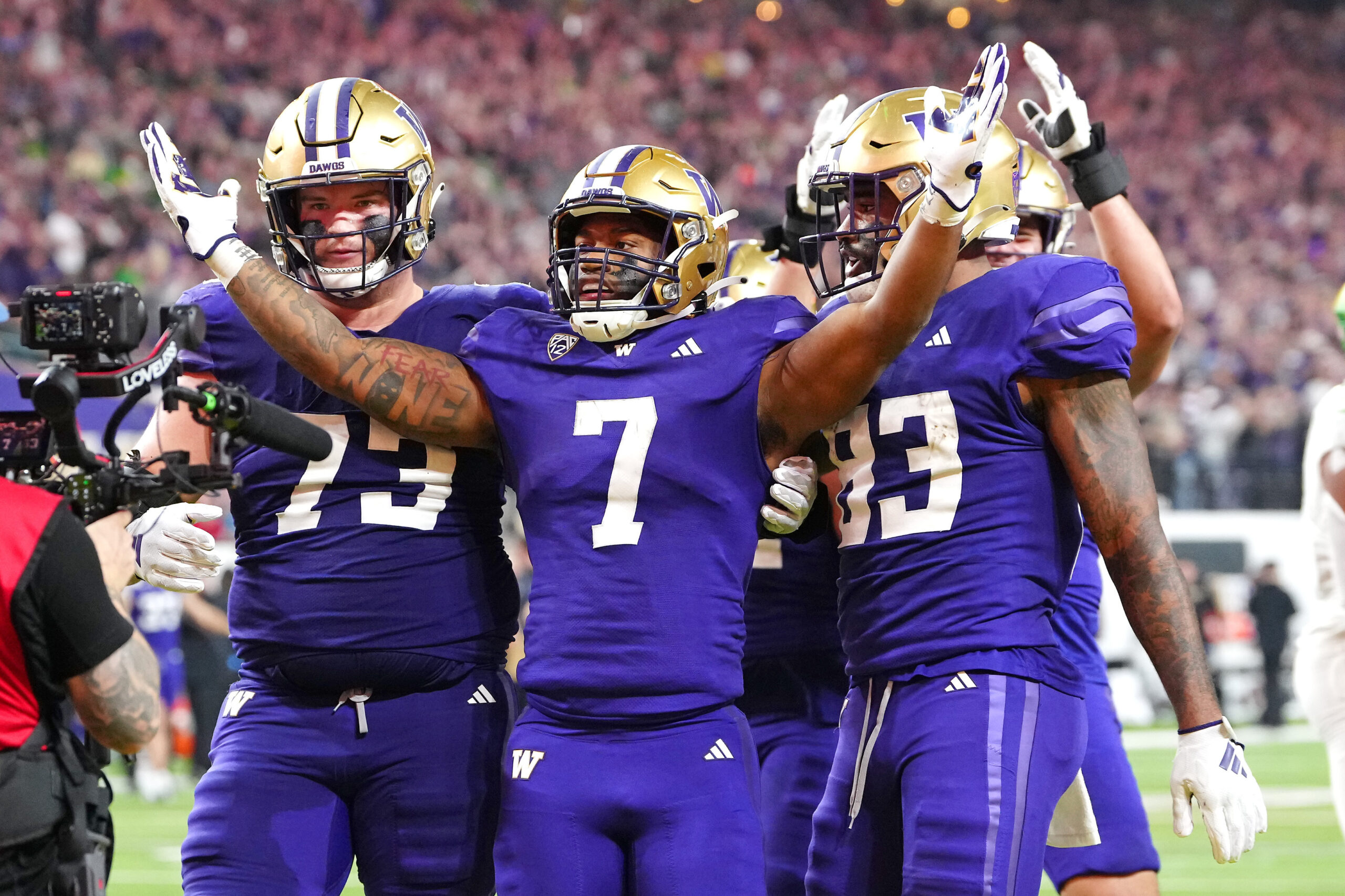 Dec 1, 2023; Las Vegas, NV, USA; Washington Huskies running back Dillon Johnson (7) celebrates with Washington Huskies offensive lineman Roger Rosengarten (73) and Washington Huskies tight end Devin Culp (83) after scoring a touchdown against the Oregon Ducks during the fourth quarter at Allegiant Stadium.