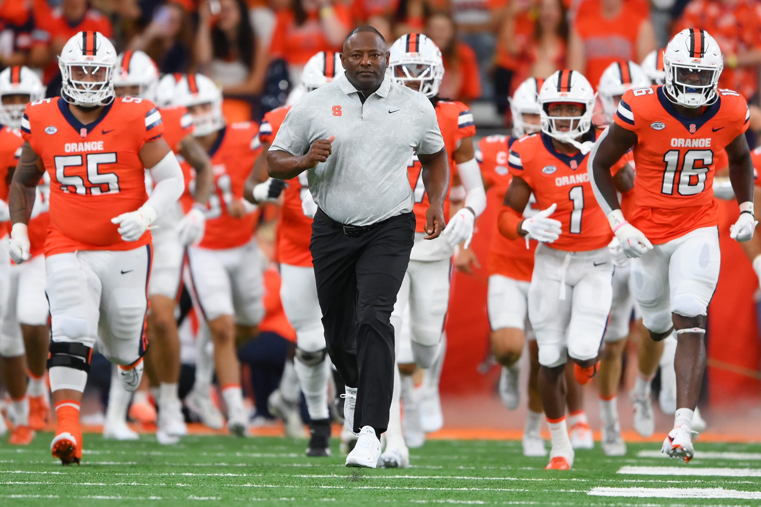 Sep 9, 2023; Syracuse, New York, USA; Syracuse Orange head coach Dino Babers leads his team on the field prior to the game against the Western Michigan Broncos at the JMA Wireless Dome.