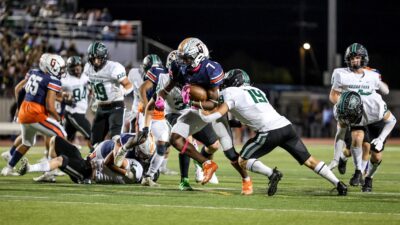 Glenn sophomore DJ Dugar (7) bulls towards the endzone as Cedar Park defenders try to slow him. Cedar Park frustrated the Grizzlies' rushing attack in a 21-10 district victory Oct. 21 at Bible Stadium.