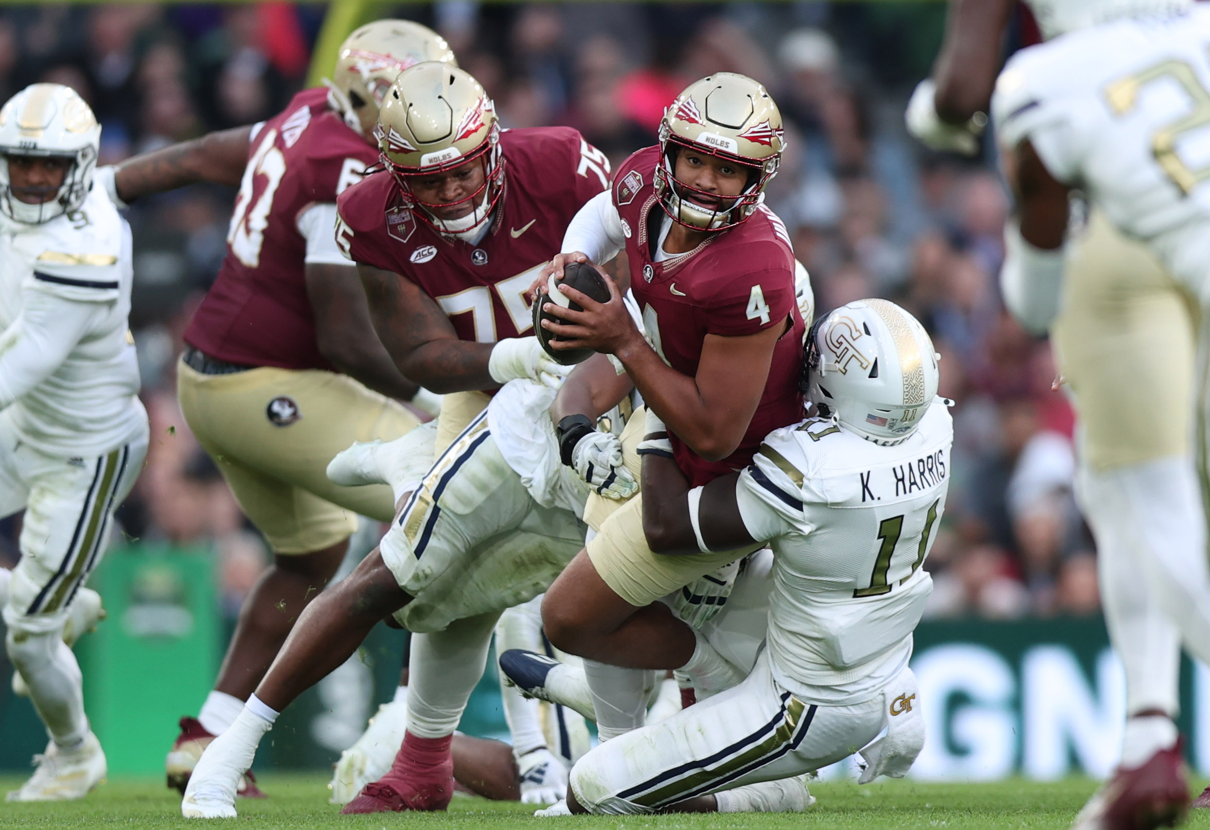 Aug 24, 2024; Dublin, IRL; Georgia Tech defensive lineman Kevin Harris II tackles Florida State University quarterback DJ Uiagalelei at Aviva Stadium. 