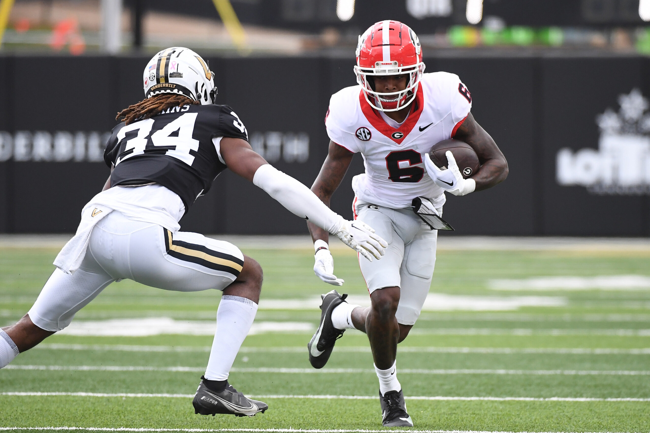 Oct 14, 2023; Nashville, Tennessee, USA; Georgia Bulldogs wide receiver Dominic Lovett (6) runs after a reception before he is tackled by Vanderbilt Commodores cornerback Quantaves Gaskins (34) during the first half at FirstBank Stadium.