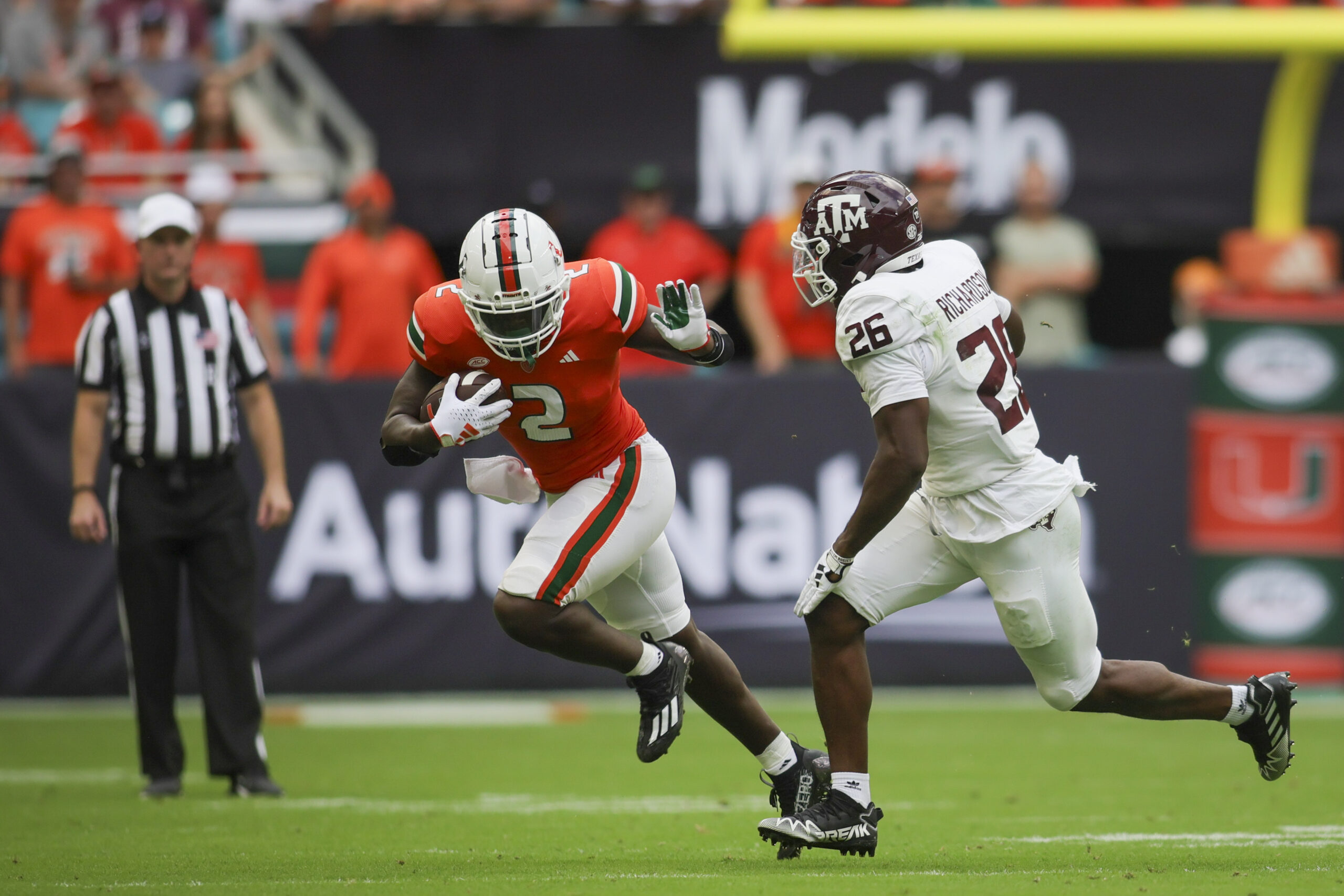 Sep 9, 2023; Miami Gardens, Florida, USA; Miami Hurricanes running back Donald Chaney Jr. (2) runs with the football against Texas A&M Aggies defensive back Demani Richardson (26) during the second quarter at Hard Rock Stadium.
