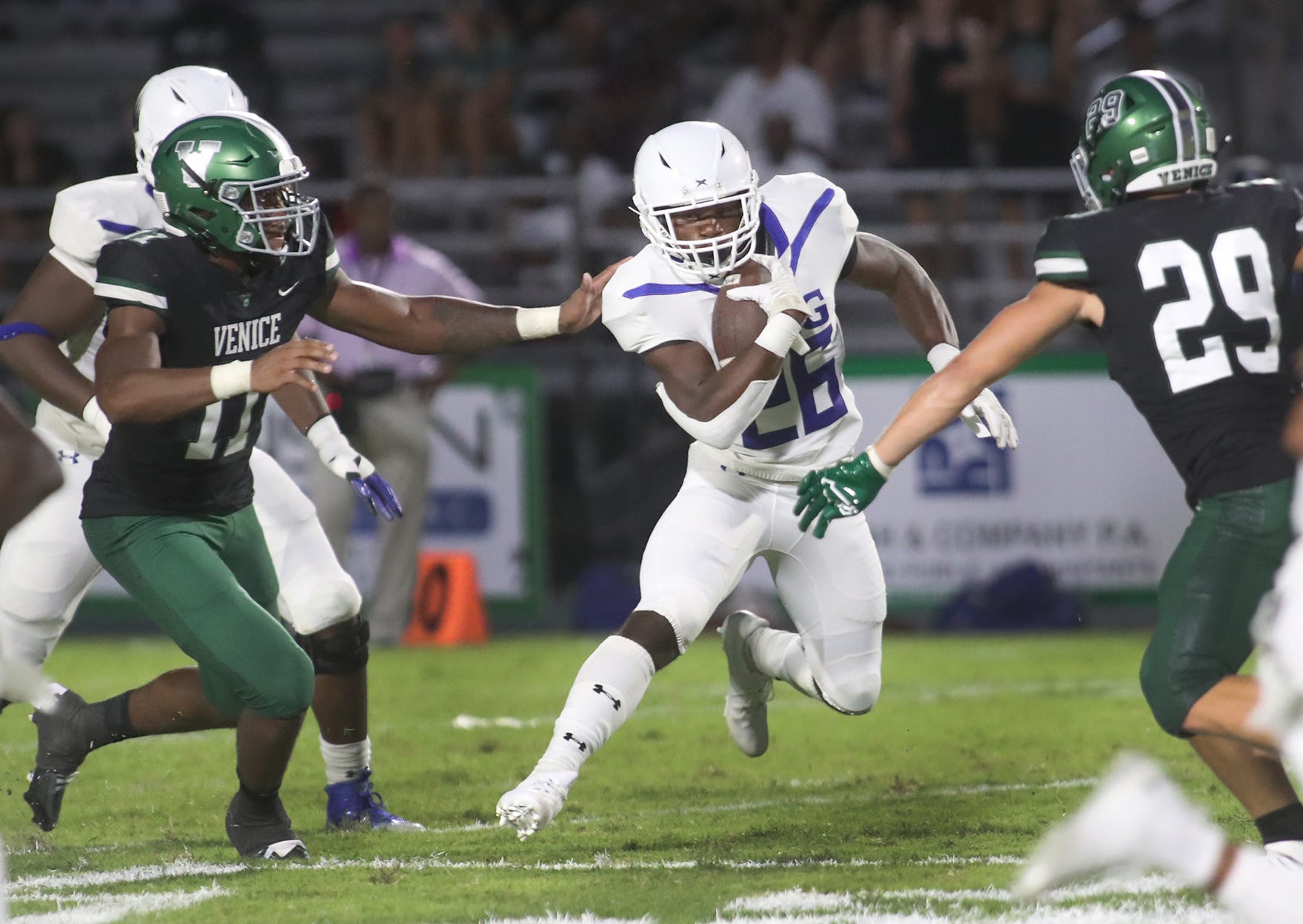 IMG running back Donovan Johnson (26) heads upfiled against Venice during their matchup at Powell-Davis Stadium in Venice.