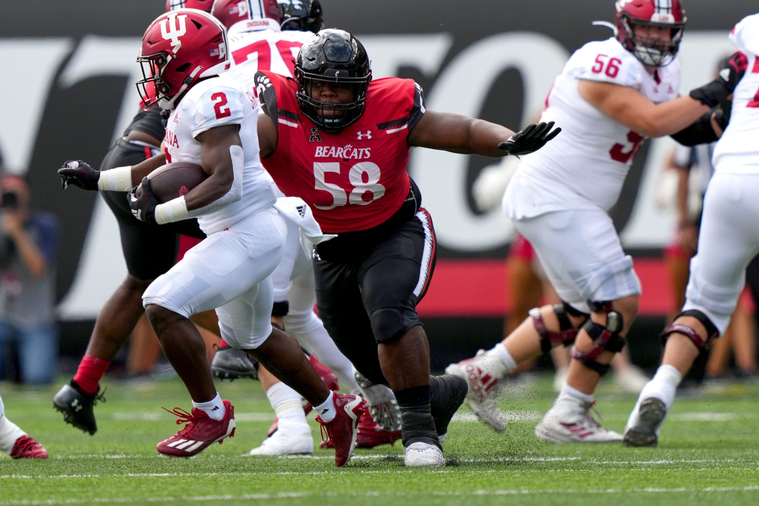 Cincinnati Bearcats defensive lineman Dontay Corleone (58) tackles Indiana Hoosiers running back Shaun Shivers (2) in the first quarter of a college football game, Saturday, Sept. 24, 2022, at Nippert Stadium in Cincinnati.