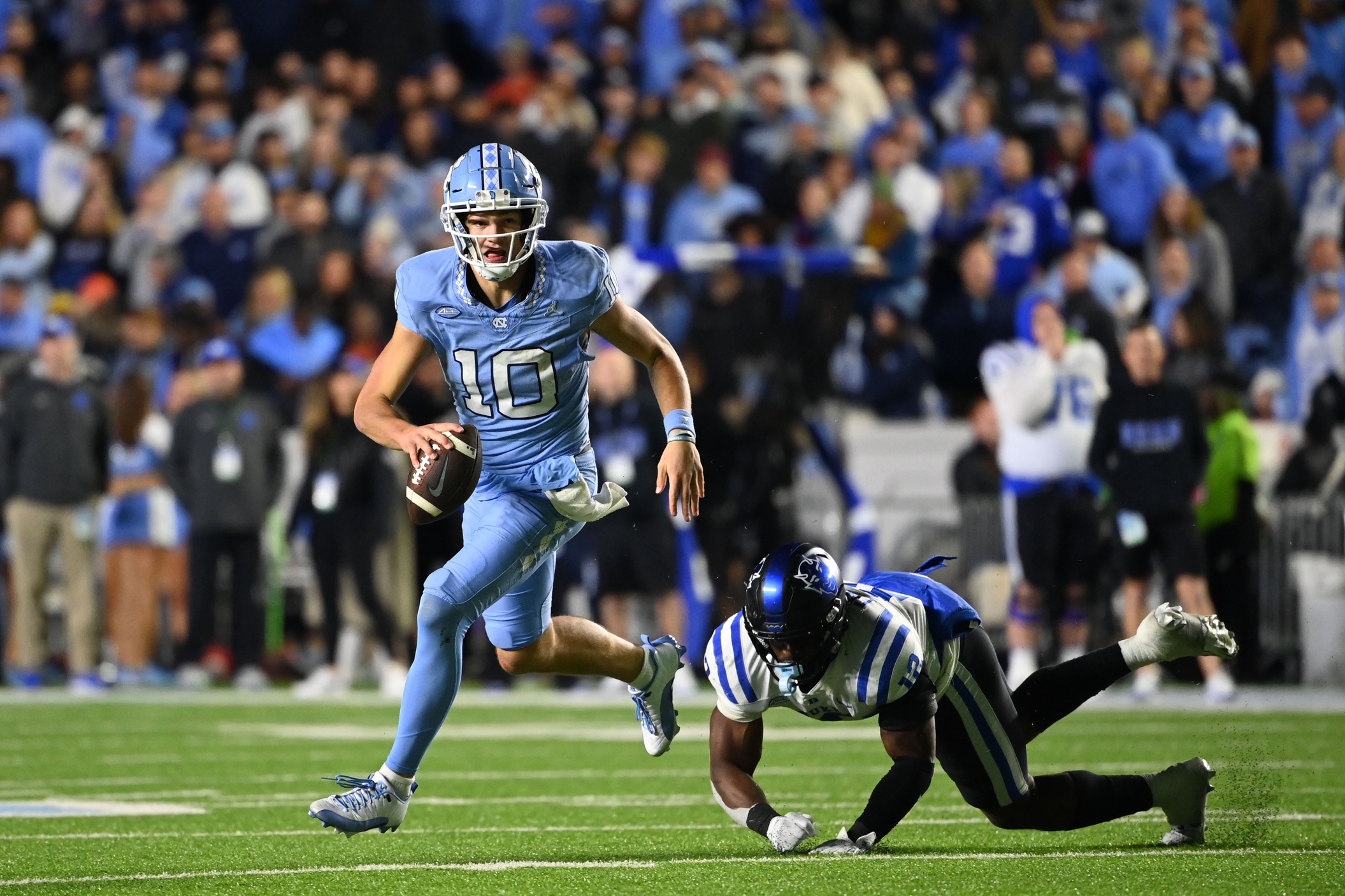 Nov 11, 2023; Chapel Hill, North Carolina, USA; North Carolina Tar Heels quarterback Drake Maye (10) looks to pass as Duke Blue Devils linebacker Tre Freeman (12) defends in the first overtime at Kenan Memorial Stadium.