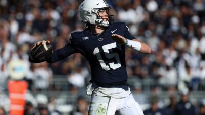 Penn State quarterback Drew Allar gets a pass off with West Virginia pressure closing in on him during the season opener at Beaver Stadium September 2