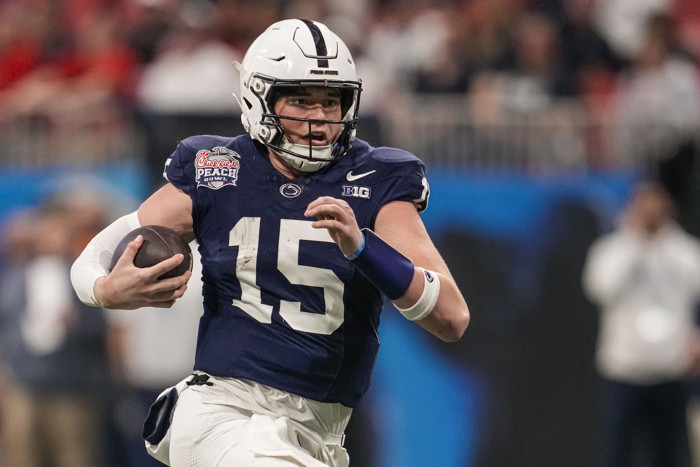 Dec 30, 2023; Atlanta, GA, USA; Penn State Nittany Lions quarterback Drew Allar (15) runs with the ball against the Mississippi Rebels during the second half at Mercedes-Benz Stadium.