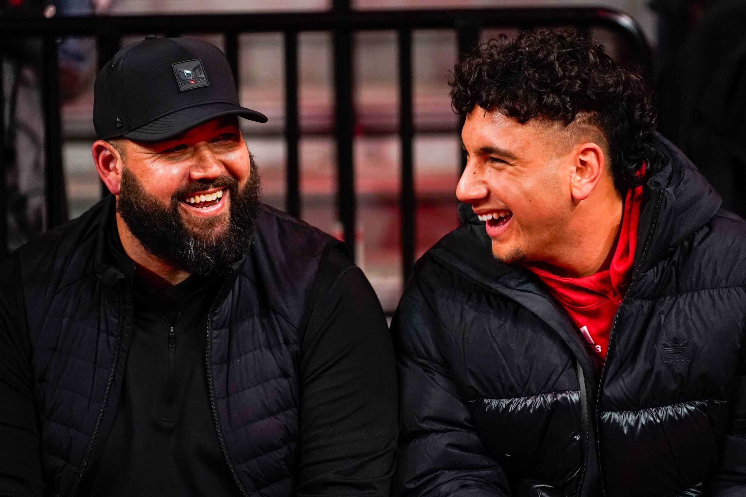 Jan 3, 2024; Lincoln, Nebraska, USA; Nebraska Cornhuskers football assistant coach Donovan Raiola (left) and Dylan Raiola smile before the game against the Indiana Hoosiers at Pinnacle Bank Arena. Dylan is the top quarterback recruit in the 2024 class.