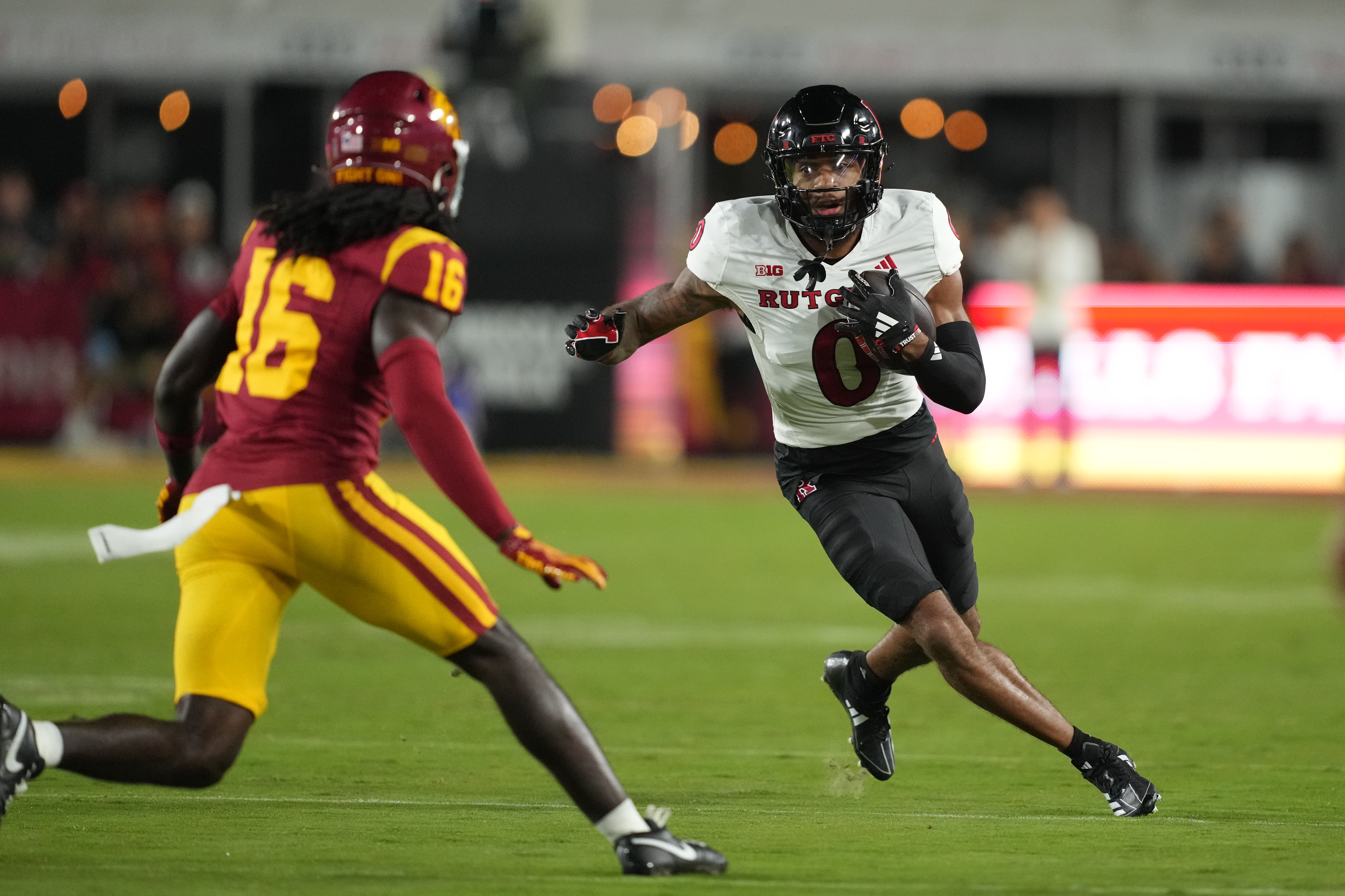 Oct 25, 2024; Los Angeles, California, USA; Rutgers Scarlet Knights wide receiver Dymere Miller (0) catches the ball against Southern California Trojans cornerback Prophet Brown (16) in the first half at United Airlines Field at Los Angeles Memorial Coliseum.