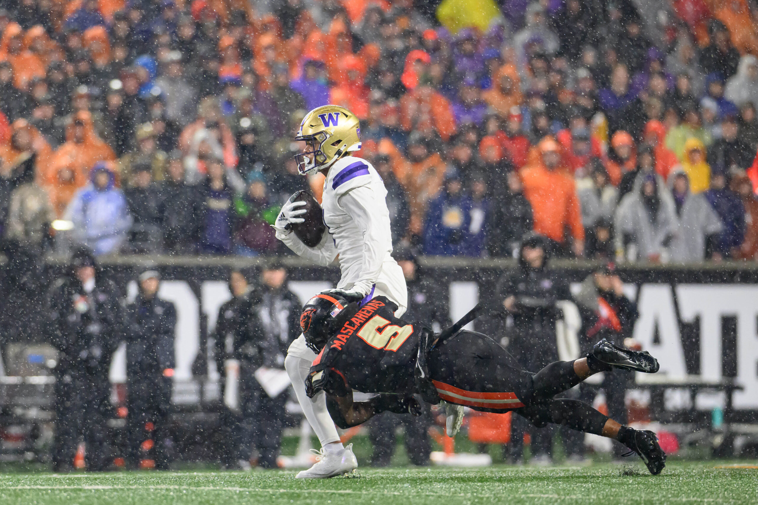 Nov 18, 2023; Corvallis, Oregon, USA; Oregon State Beavers linebacker Easton Mascarenas-Arnold (5) tackles Washington Huskies wide receiver Rome Odunze (1) during the second quarter at Reser Stadium.