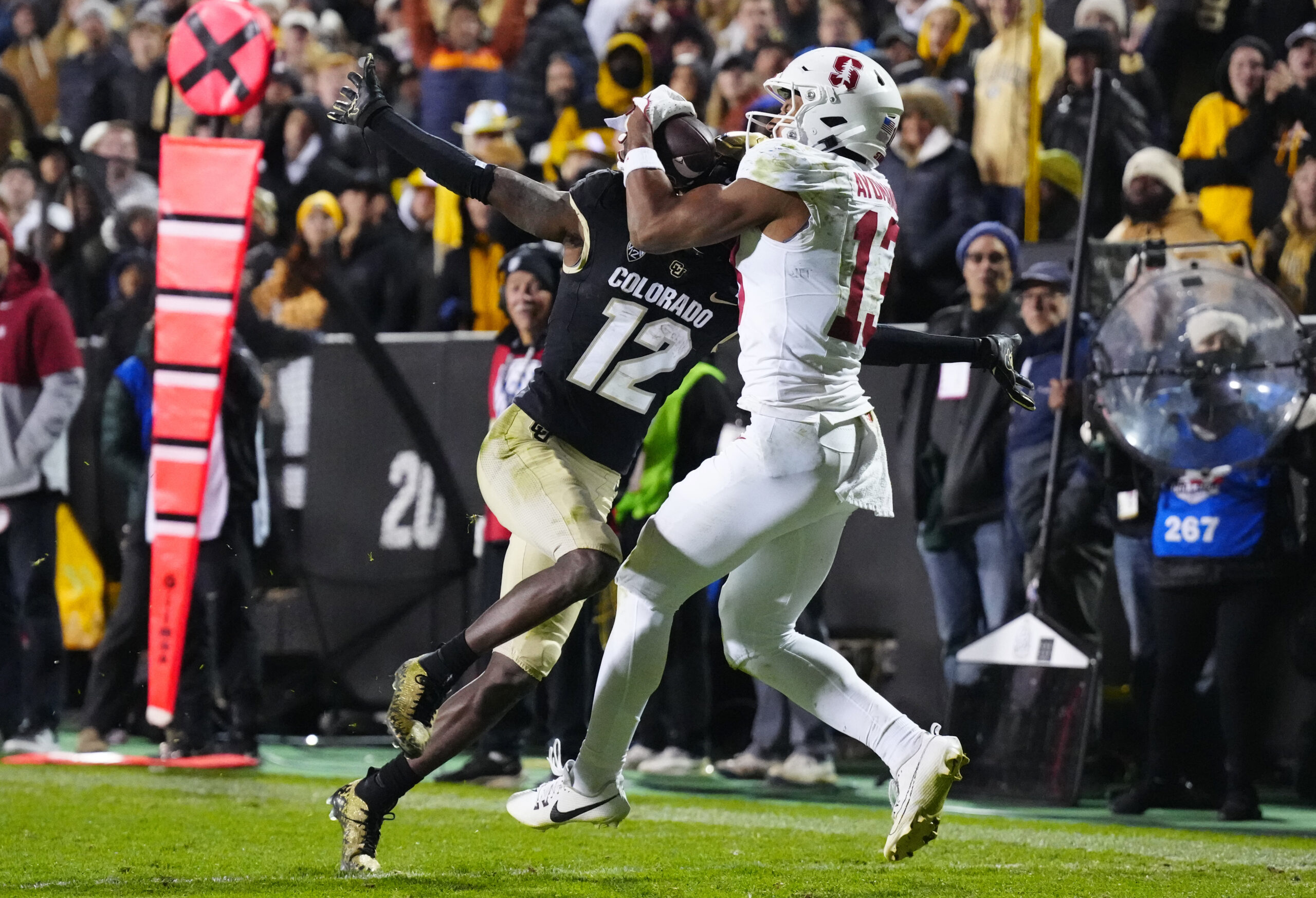 Boulder, Colorado, USA; Stanford Cardinal wide receiver Elic Ayomanor (13) pulls in a touchdown behind the pack of Colorado Buffaloes cornerback Travis Hunter (12) in overtime at Folsom Field.