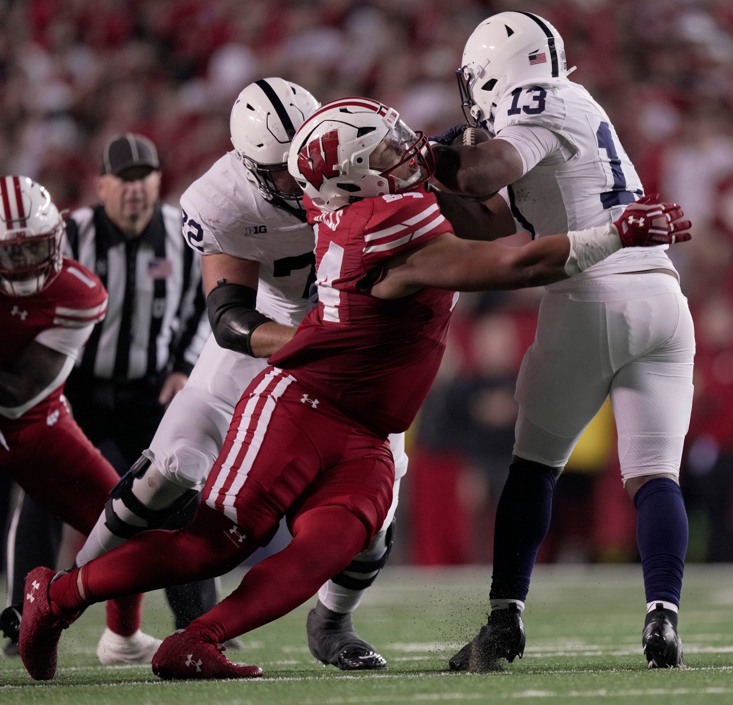 Wisconsin defensive lineman Elijah Hills (94) tackles Penn State running back Kaytron Allen (13) for a two-yard loss during the third quarter of their game Saturday, October 26, 2024 at Camp Randall Stadium in Madison, Wisconsin. Penn State beat Wisconsin 28-13.