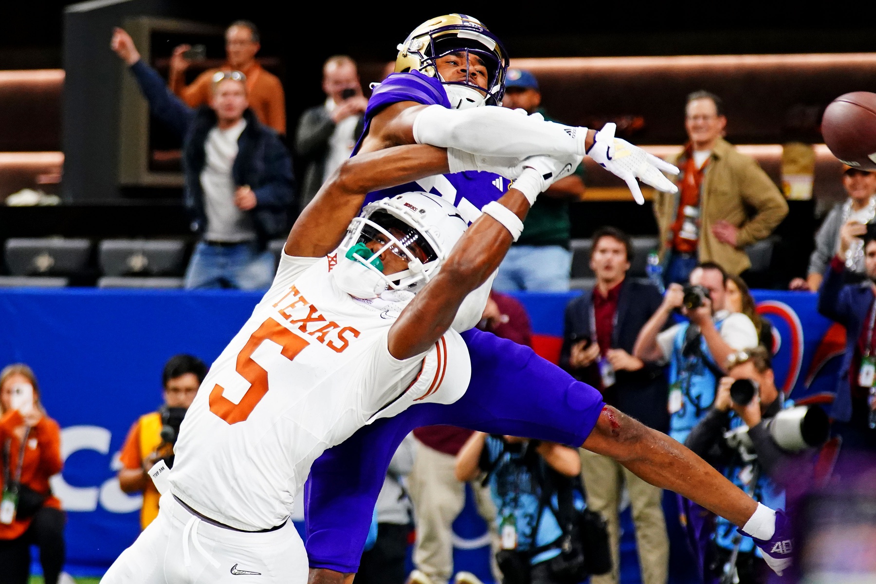 Jan 1, 2024; New Orleans, LA, USA; Washington Huskies cornerback Elijah Jackson (25) knocks the ball away from Texas Longhorns wide receiver Adonai Mitchell (5) during the fourth quarter in the 2024 Sugar Bowl college football playoff semifinal game at Caesars Superdome.